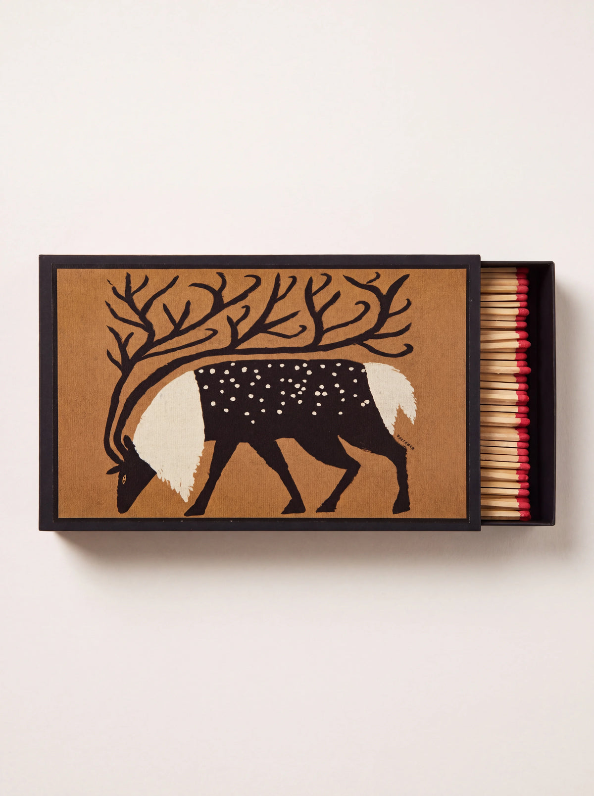 Large matchbox with reindeer illustration on kraft paper, partially open showing red-tipped matches
