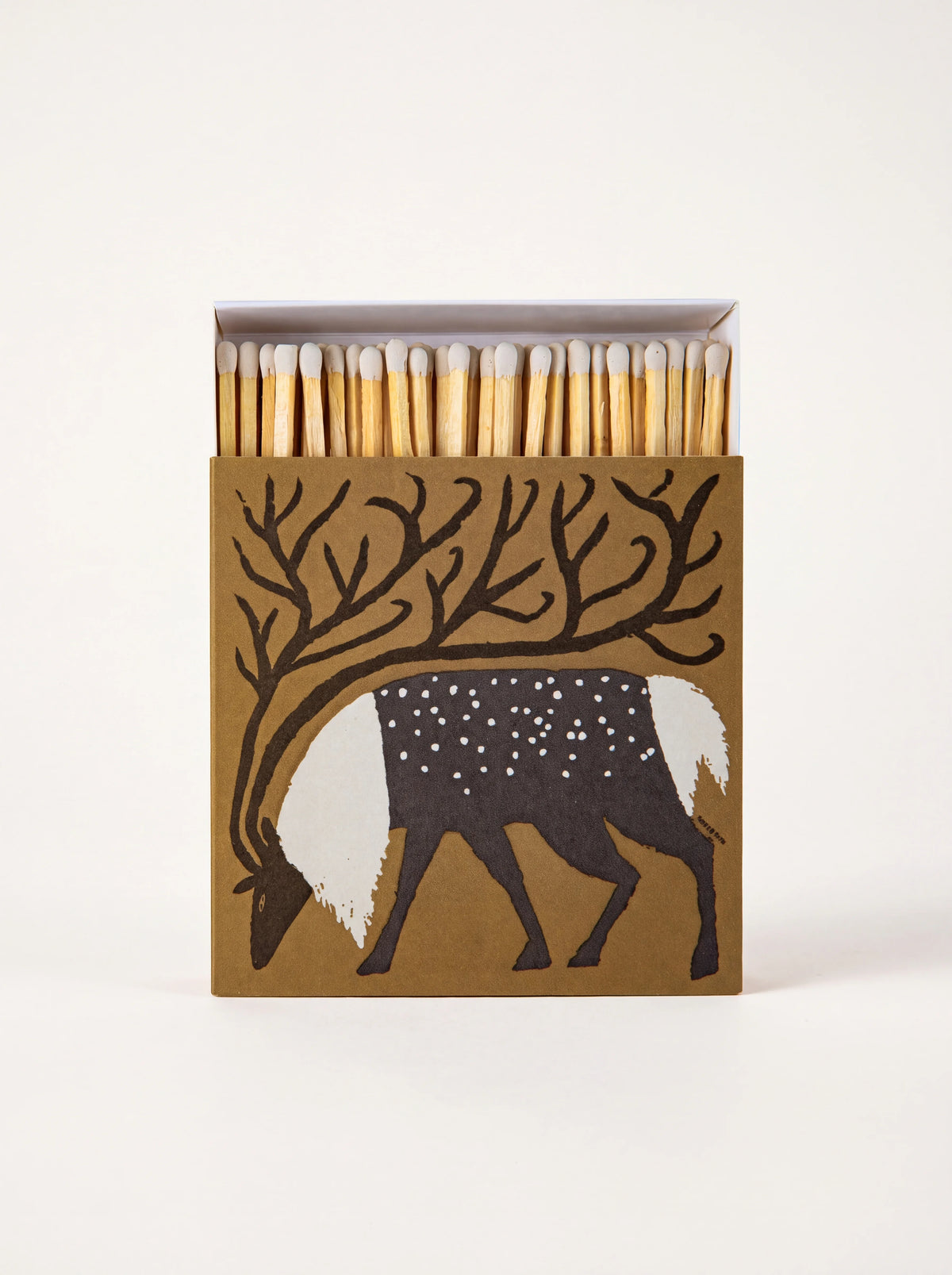 Square matchbox with a reindeer illustration, open to show white-tipped wooden matches