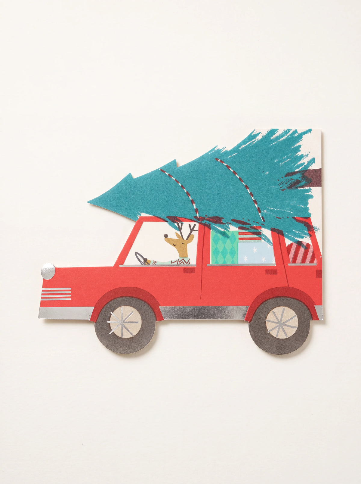Paper napkin shaped like a red car with a reindeer driver, Christmas tree on the roof and silver-foil details