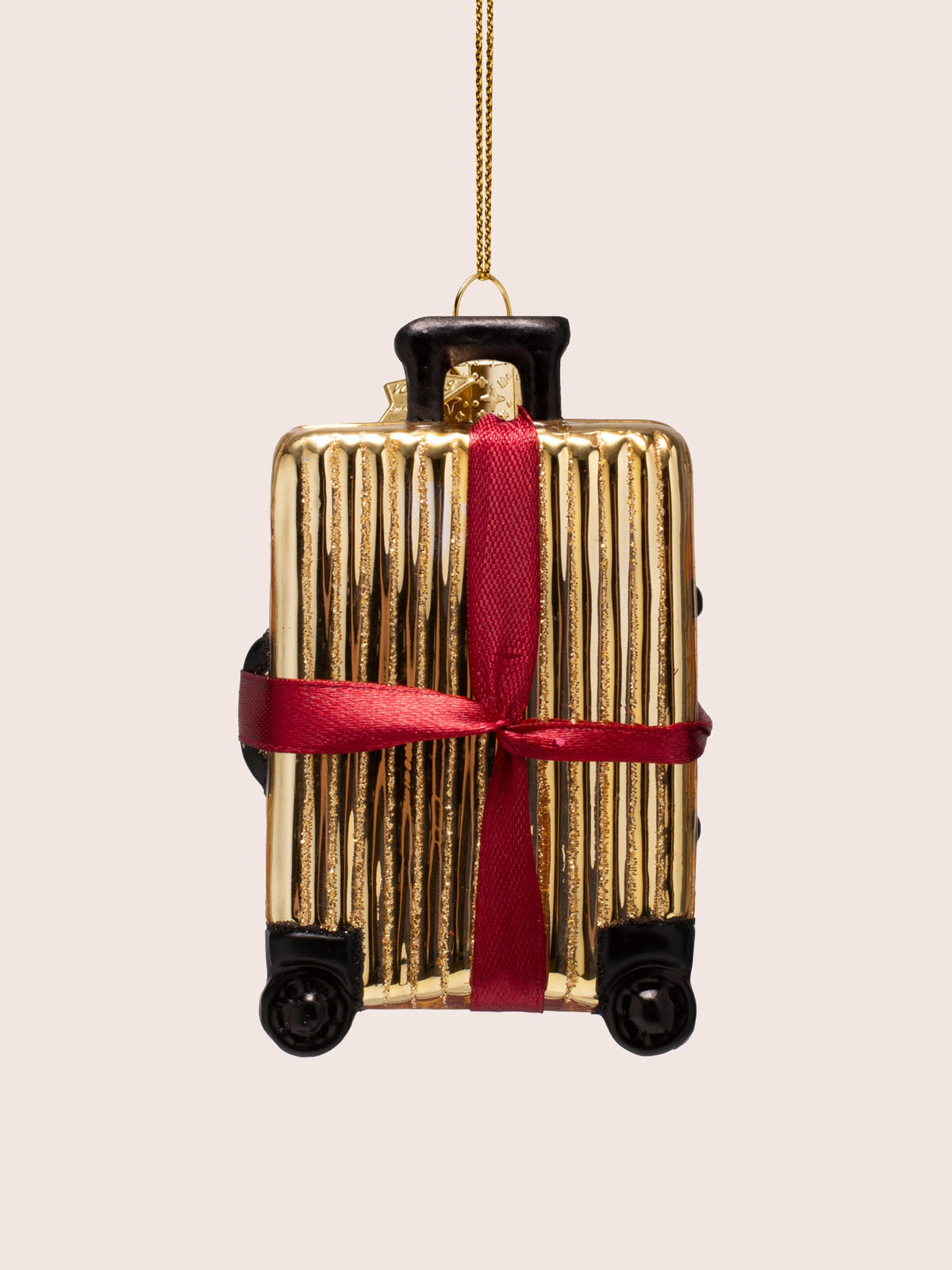 Back view of the gold ribbed suitcase ornament showing the ribbon crossed flat without the bow