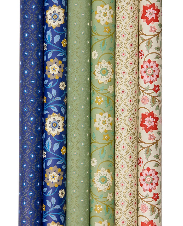 Six rolls of wrapping paper in coordinating patterns and colours including sage green, navy and cream