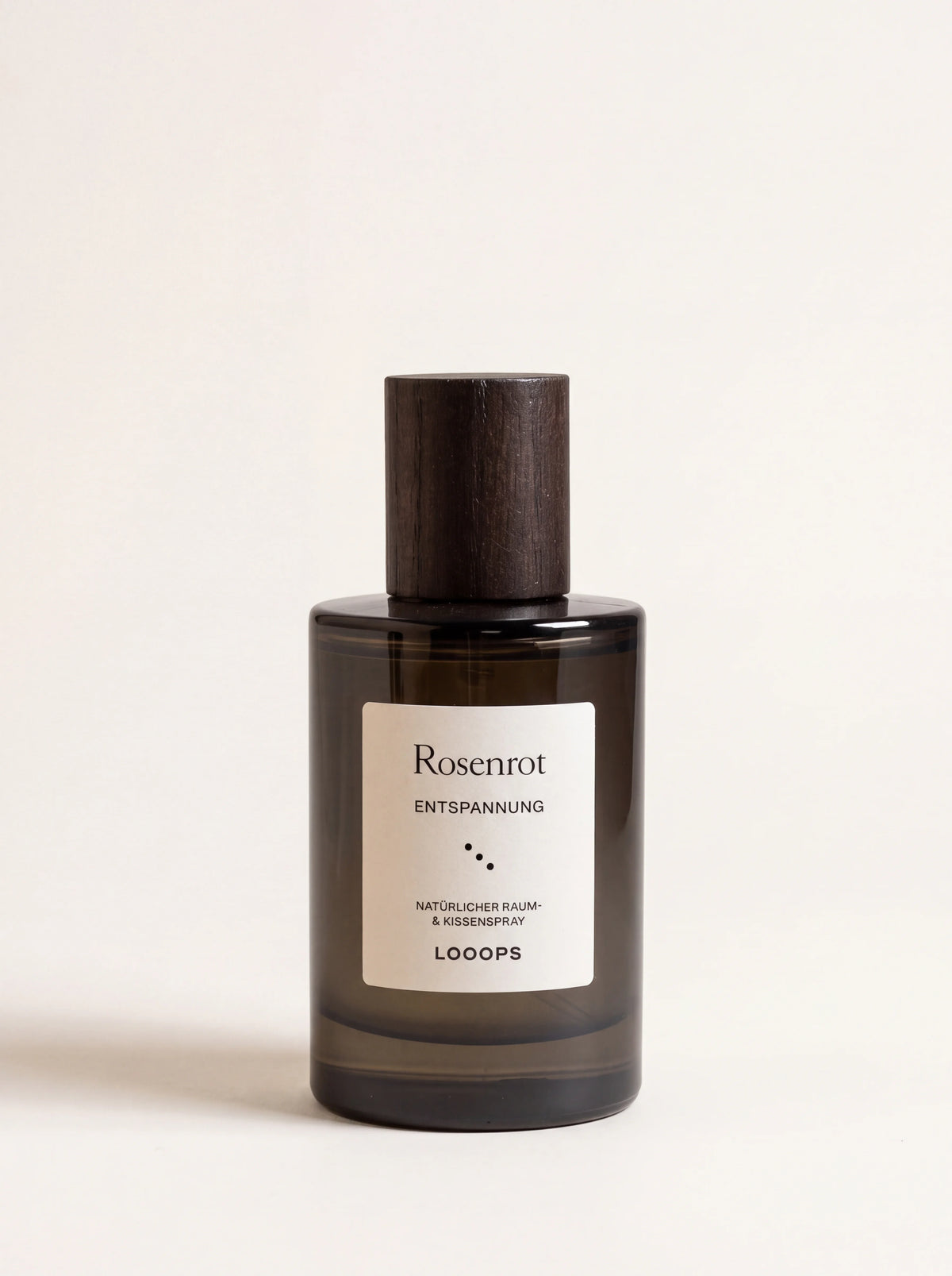 Rosenrot room spray in a tinted glass bottle with a dark stained ash wood cap