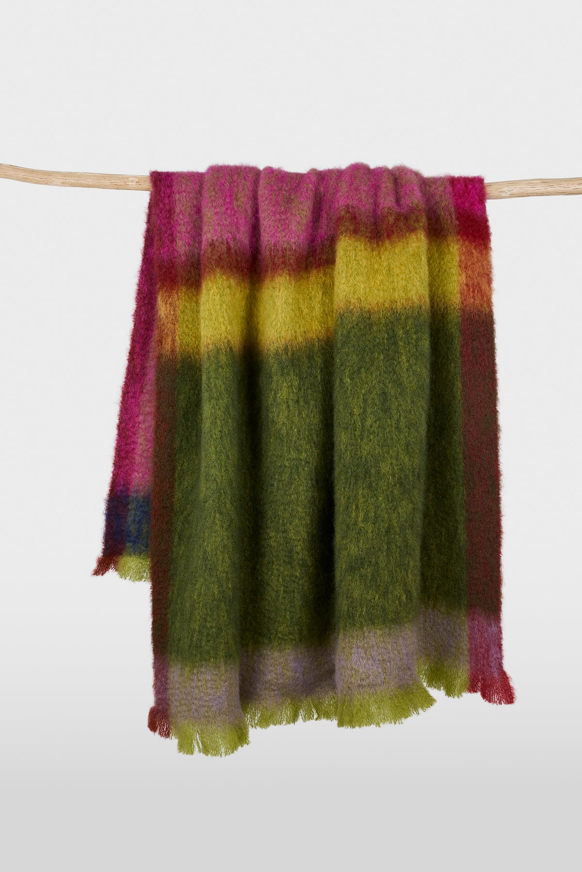 Mohair-blend throw in broad blocks of green, yellow and pink, showing its brushed texture and fringed ends