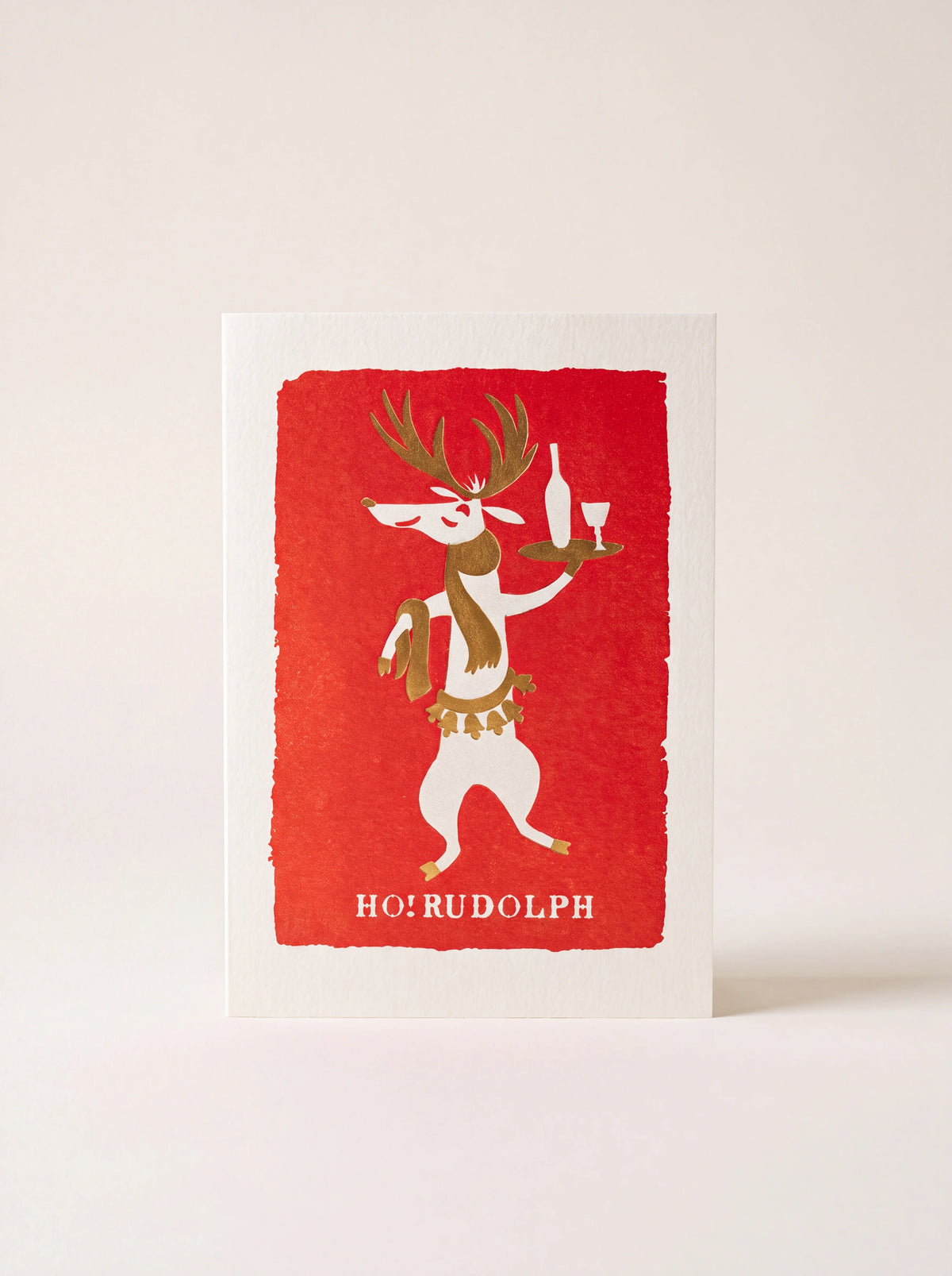 Christmas card with an illustrated reindeer holding a drinks tray on a red background and text HO! RUDOLPH