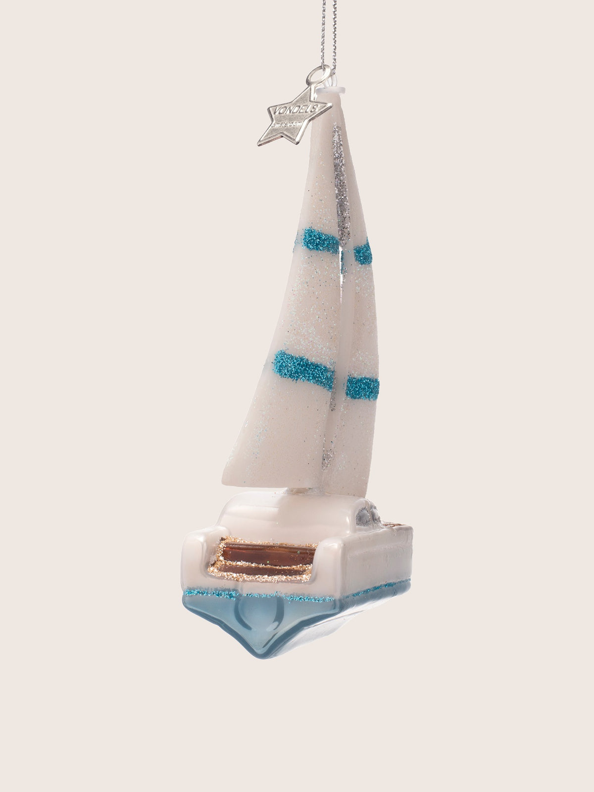 Sailing boat ornament viewed from the stern, showing the cockpit and hull profile
