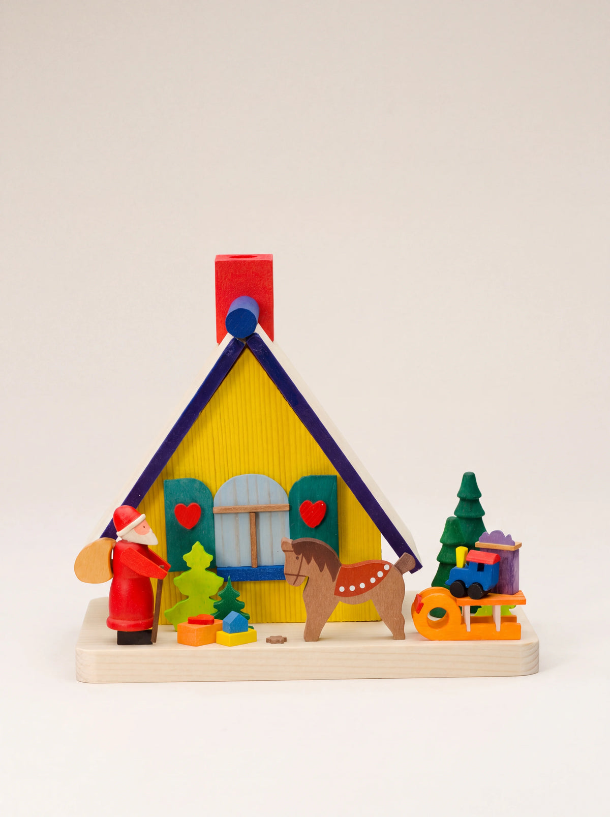 Painted maple wood incense house with a yellow facade, red chimney, Santa figurine, wooden horse and toys