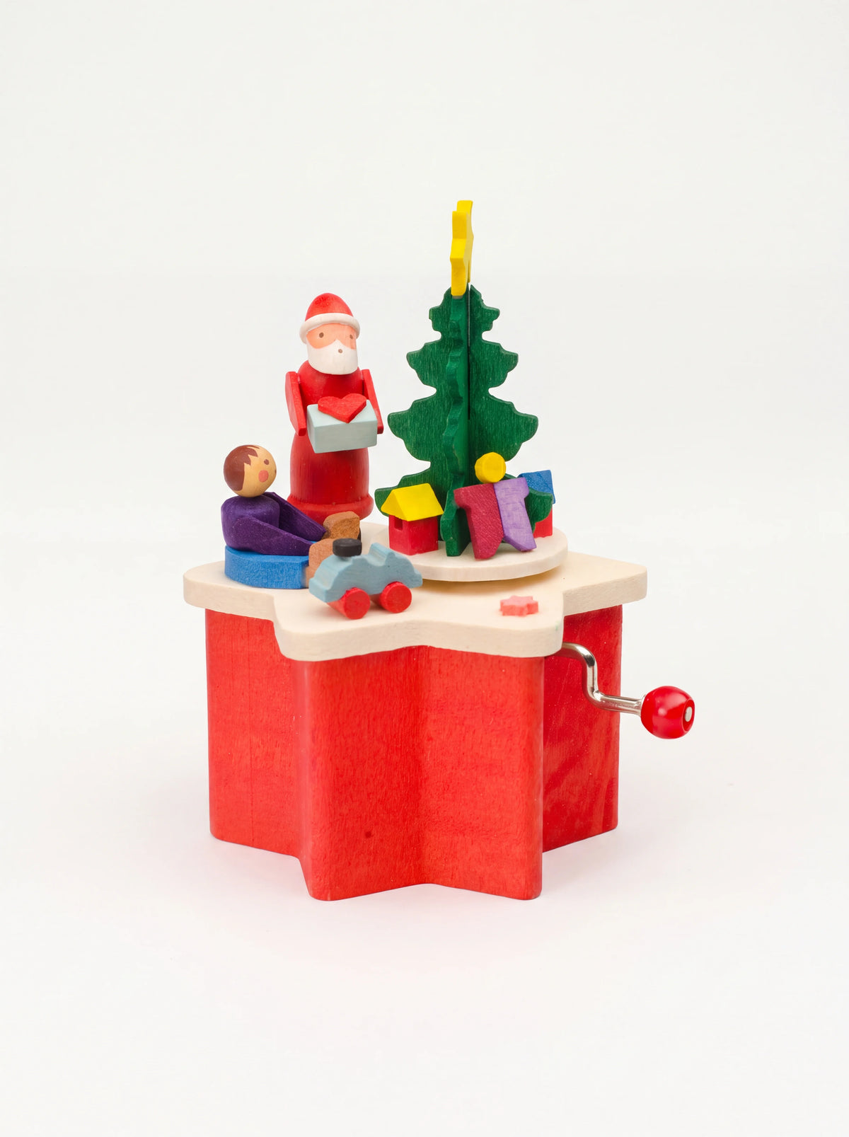Wooden music box with a red star-shaped base, hand crank, and painted figures of Santa Claus and a Christmas tree