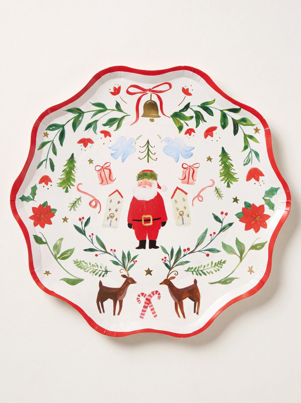 Scalloped paper dinner plate with red rim and illustration of Santa Claus, reindeer, and festive greenery