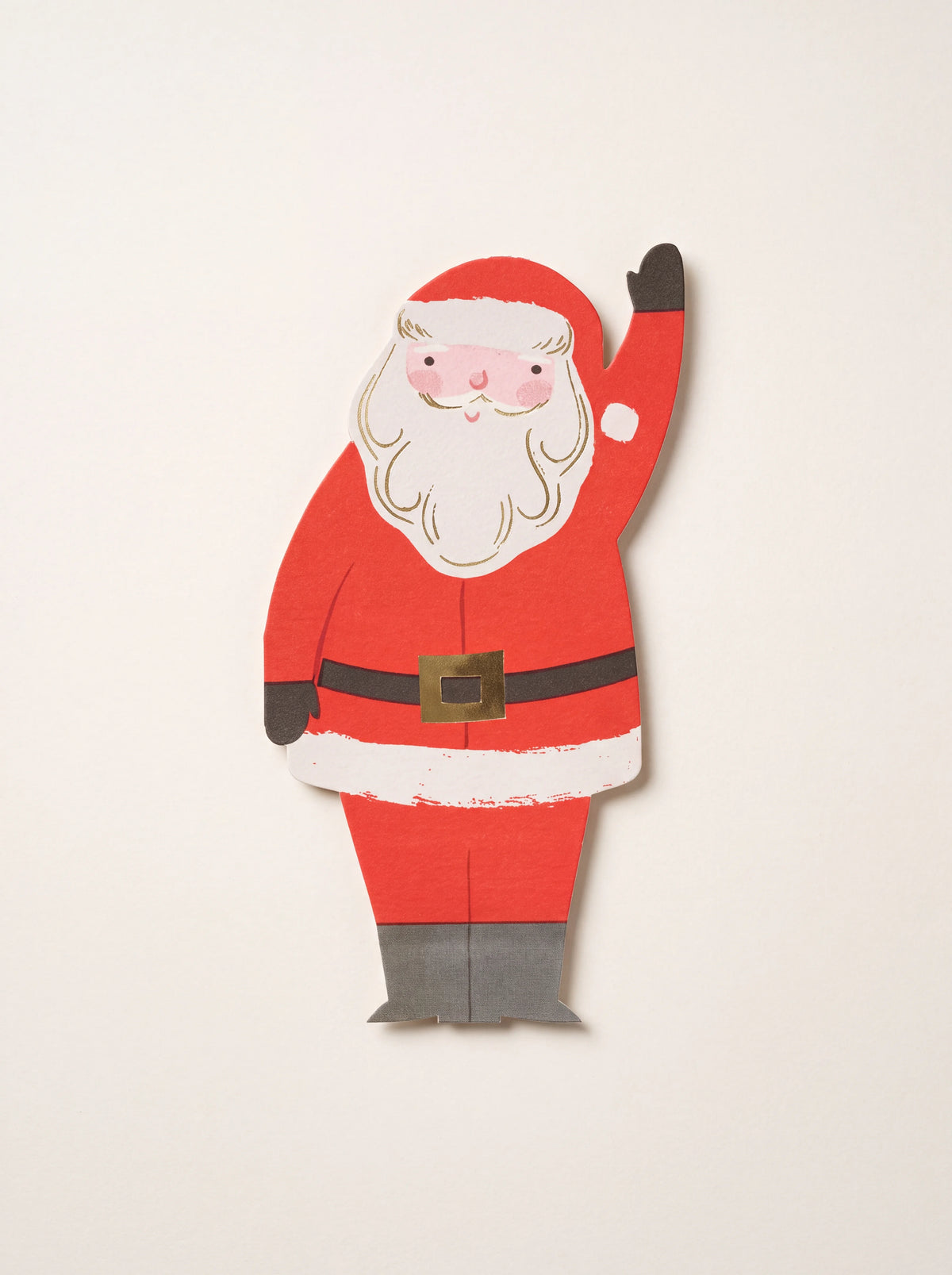 Die-cut paper napkin shaped like a waving Santa Claus with gold foil details on the beard and belt buckle