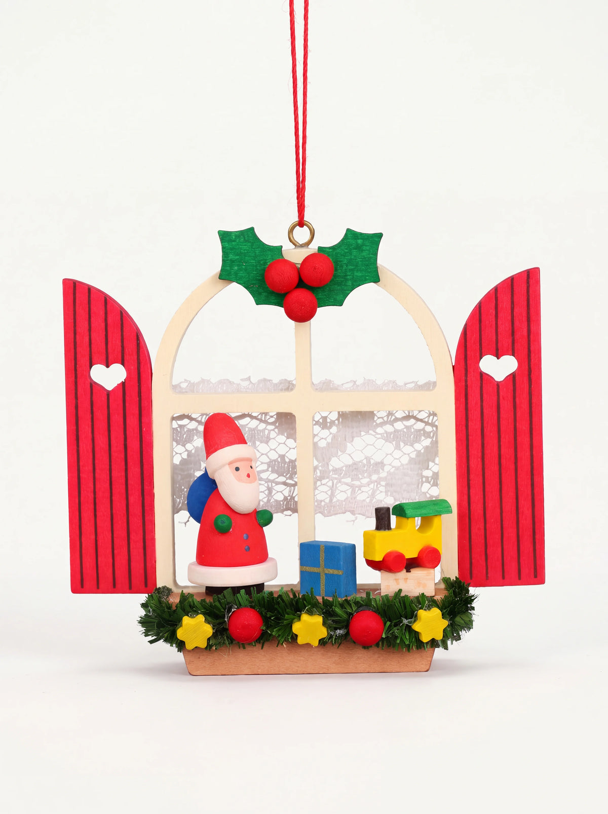 Wooden arched window ornament with red shutters, featuring a Santa figure and toy train inside