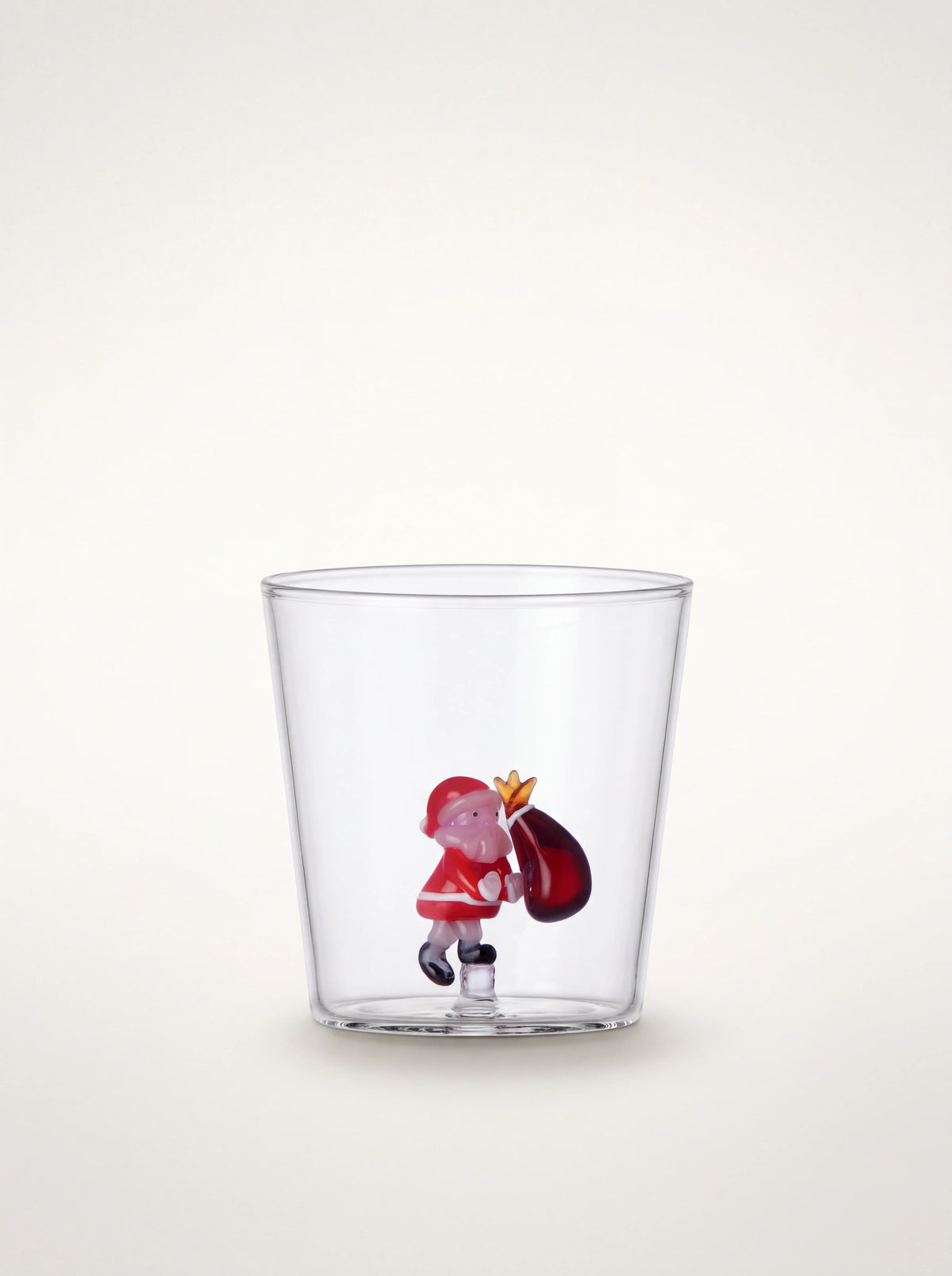 Clear borosilicate glass tumbler with an internal glass Santa figure carrying a sack at the base