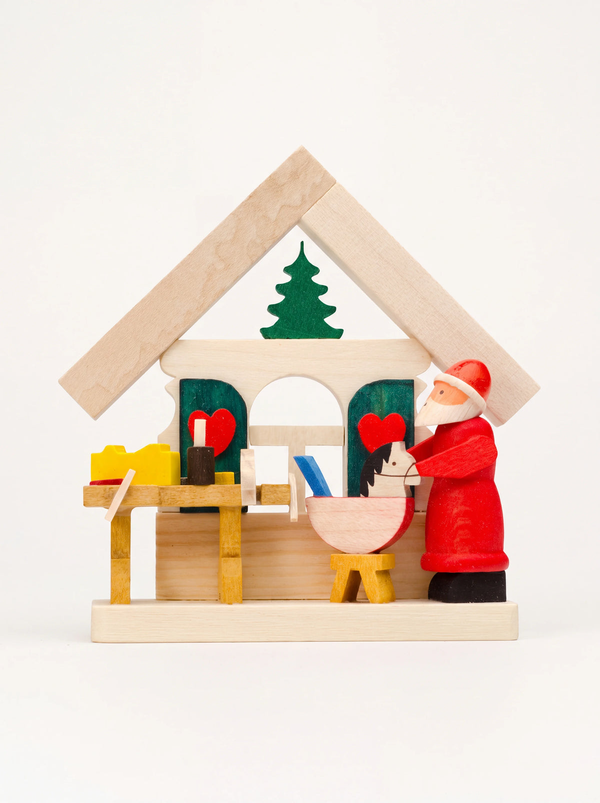House-shaped wooden Santa workshop ornament with painted Santa, workbench, and small rocking horse