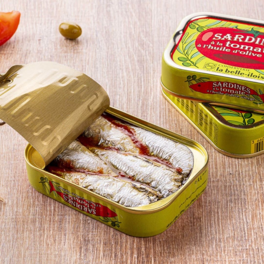 Open sardine tin showing whole sardines packed in tomato and olive oil