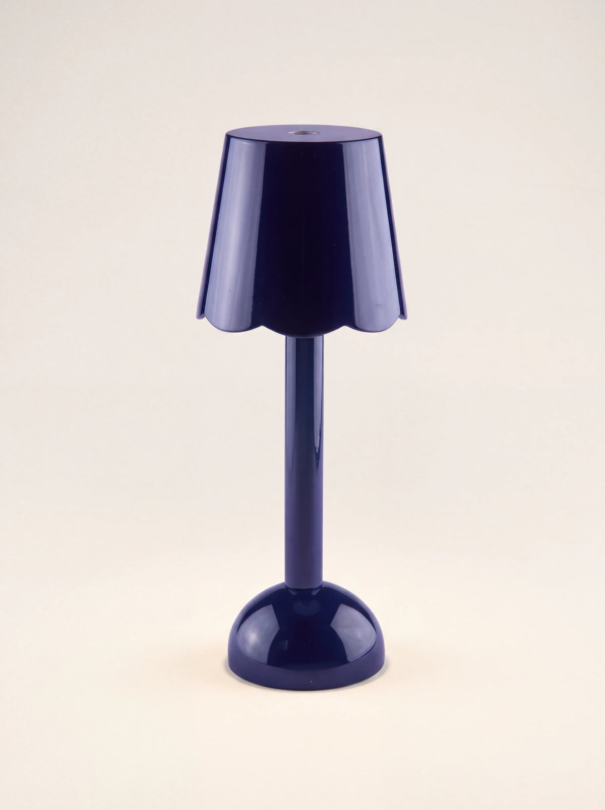 Glossy navy LED table lamp with a scalloped shade, slim stem and rounded base