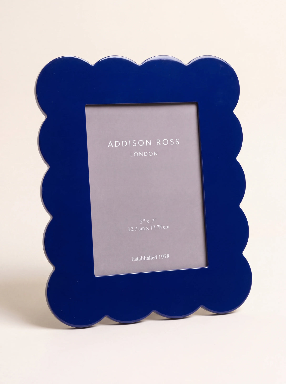 Navy lacquer photo frame with a scalloped border and high-gloss finish