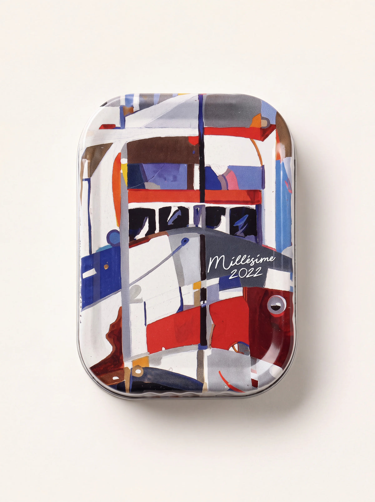Sardine tin lid featuring colourful ship artwork and Millésime 2022 lettering