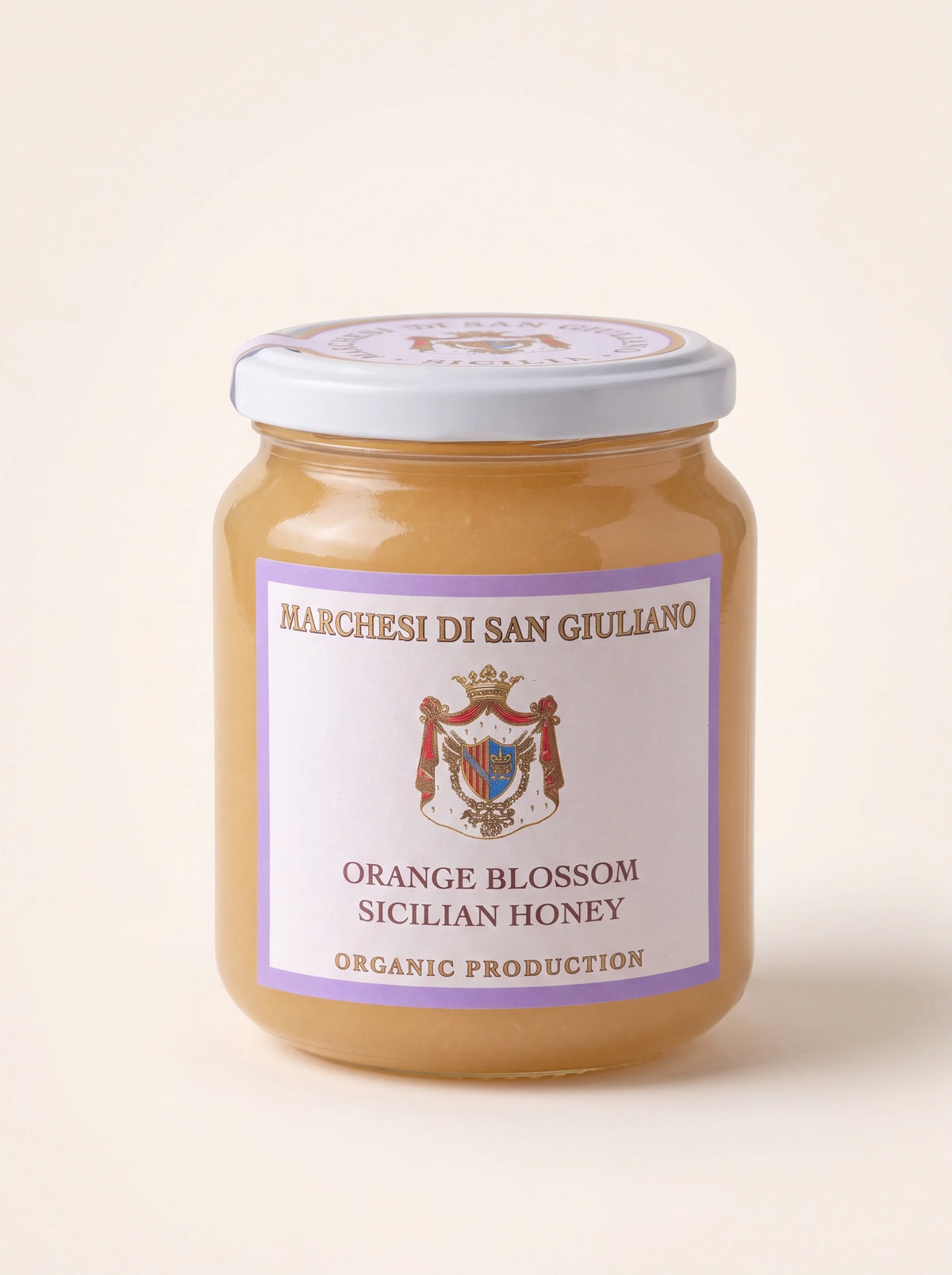 Glass jar of light orange blossom honey with a white screw lid and labelled Orange Blossom Sicilian Honey