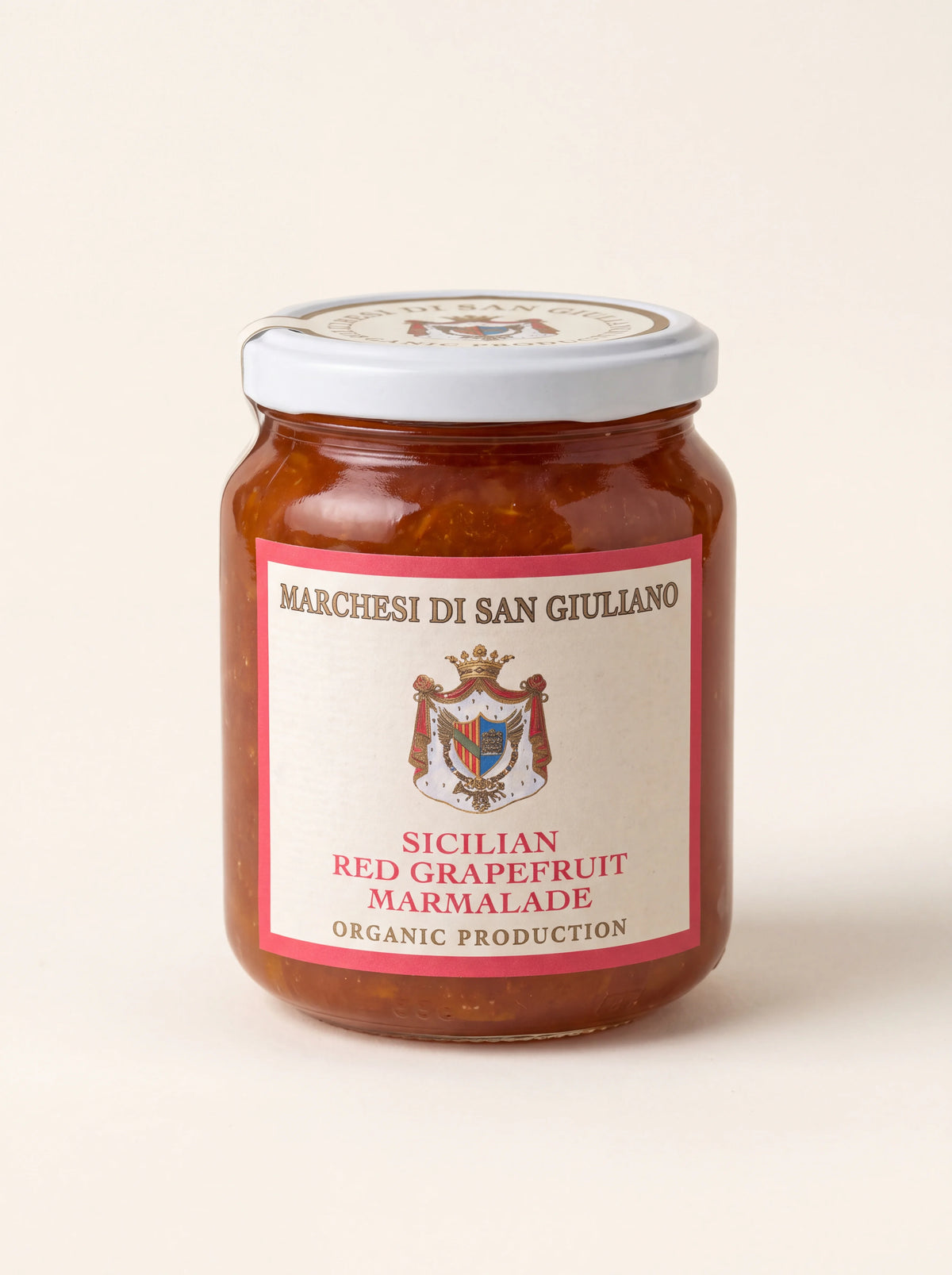 Glass jar of organic Sicilian red grapefruit marmalade with a white screw-top lid
