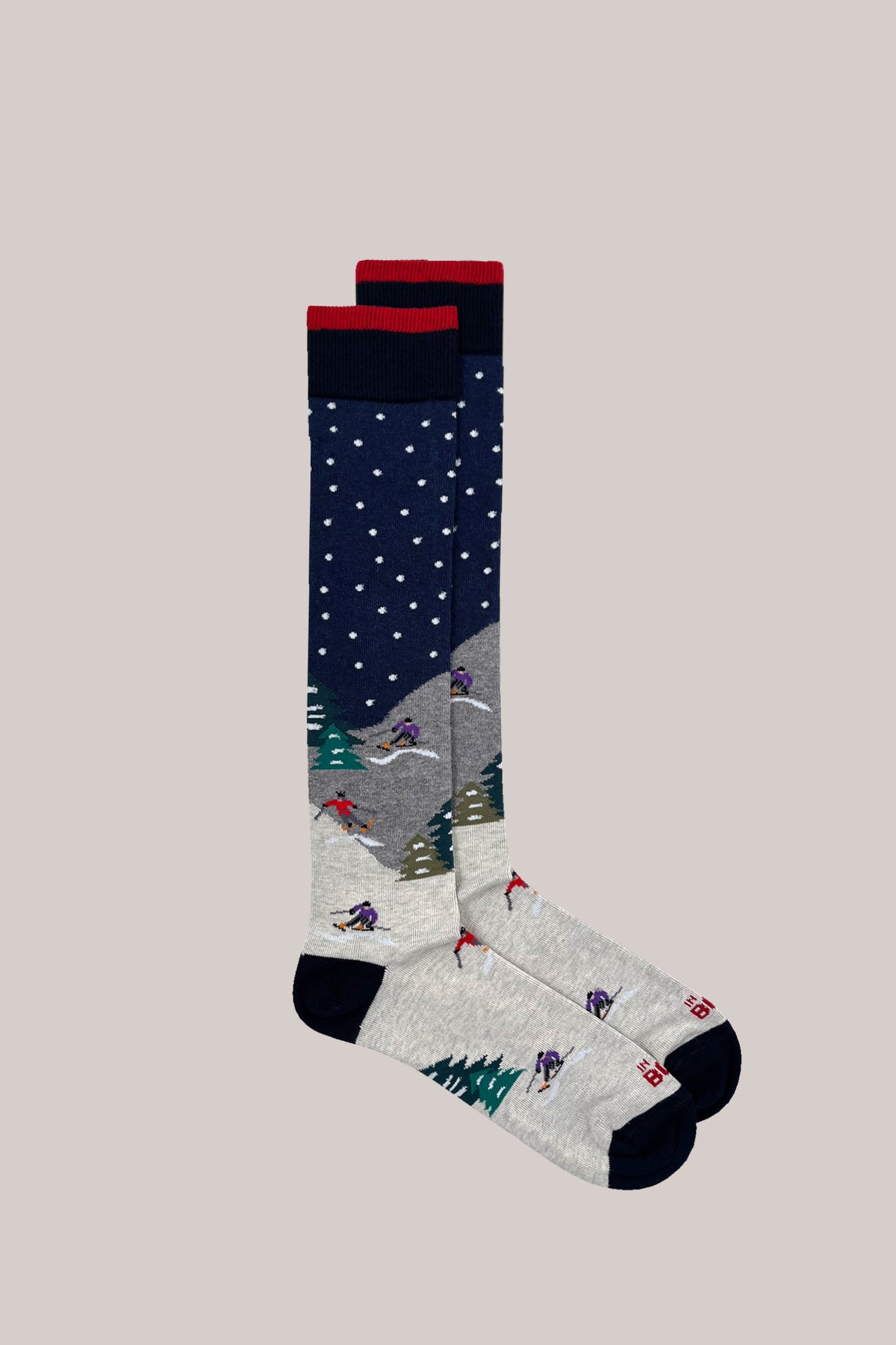 Knee-high cotton socks with knitted alpine ski motif, snowflake pattern, and red-trimmed ribbed cuffs