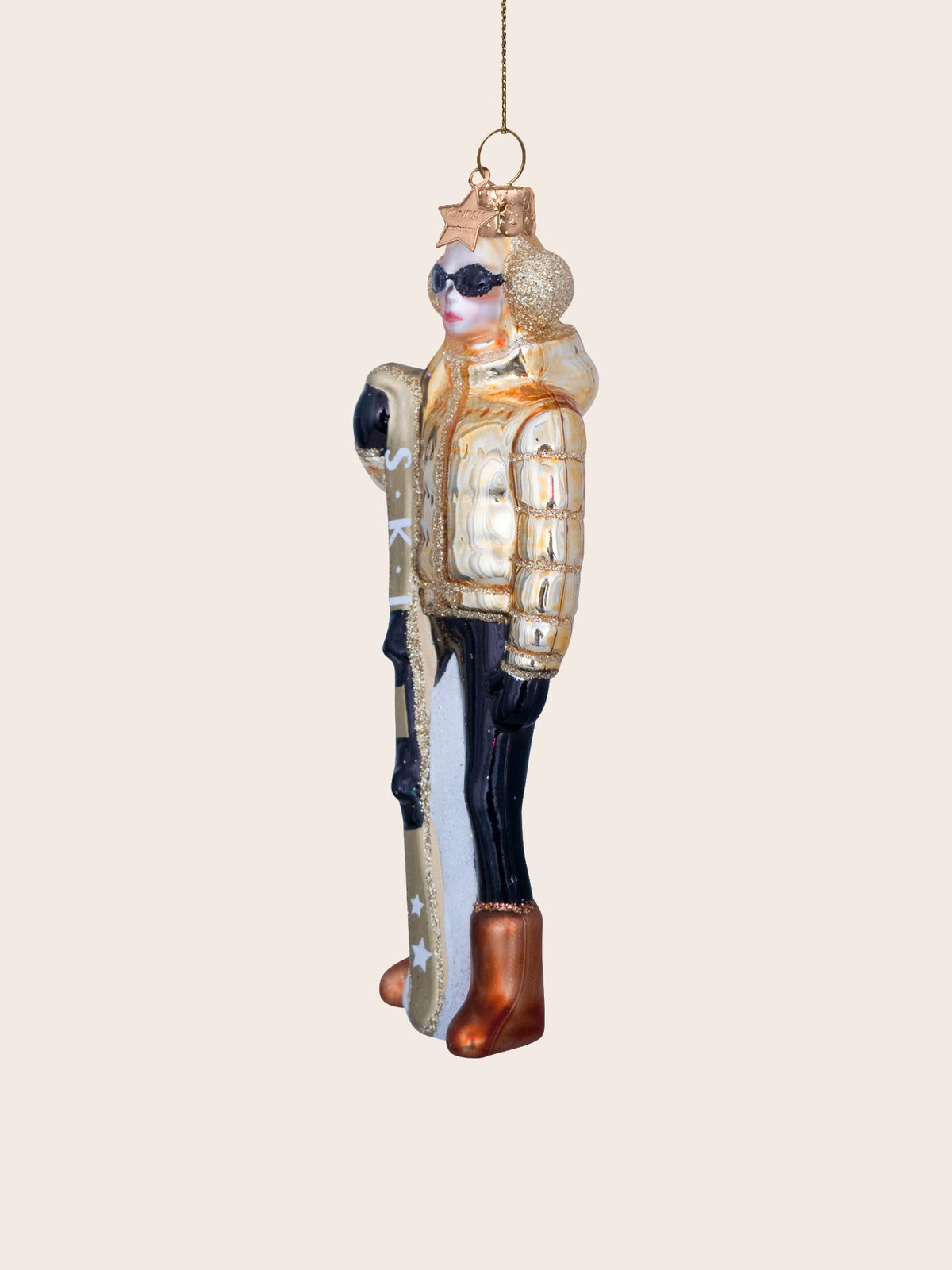Three-quarter view showing the glitter earmuff, hood and ski printed with the word SKI