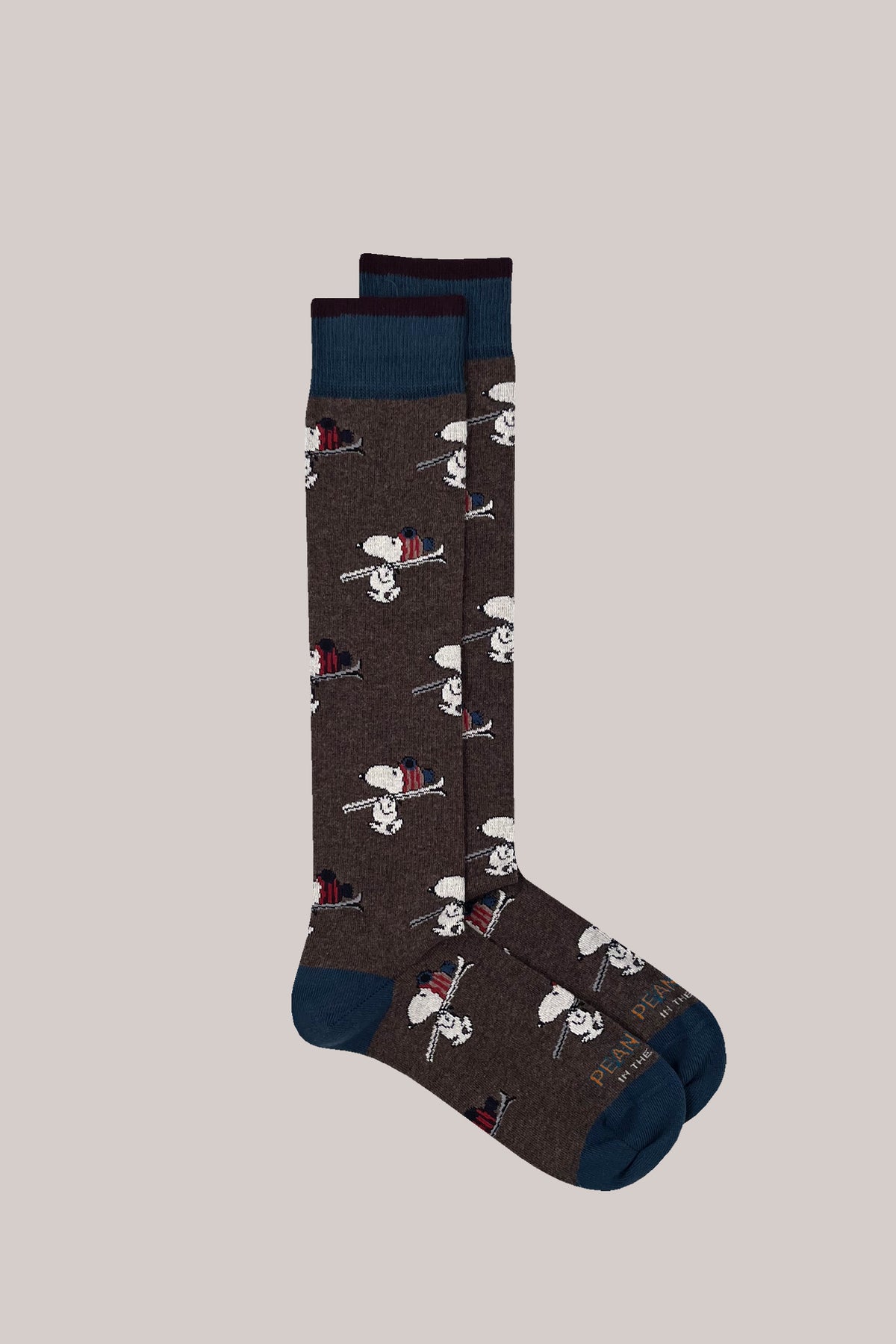 Brown cotton socks with an all-over skiing Snoopy pattern and contrasting blue cuffs, heels and toes