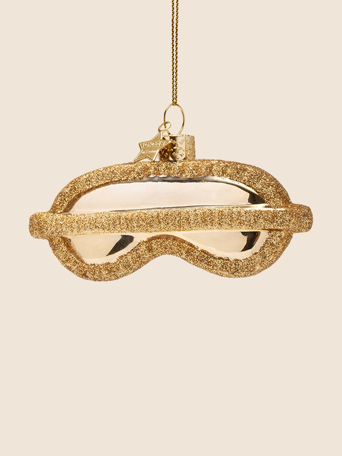 Reverse side of the sleeping mask ornament with a gold glitter horizontal strap detail