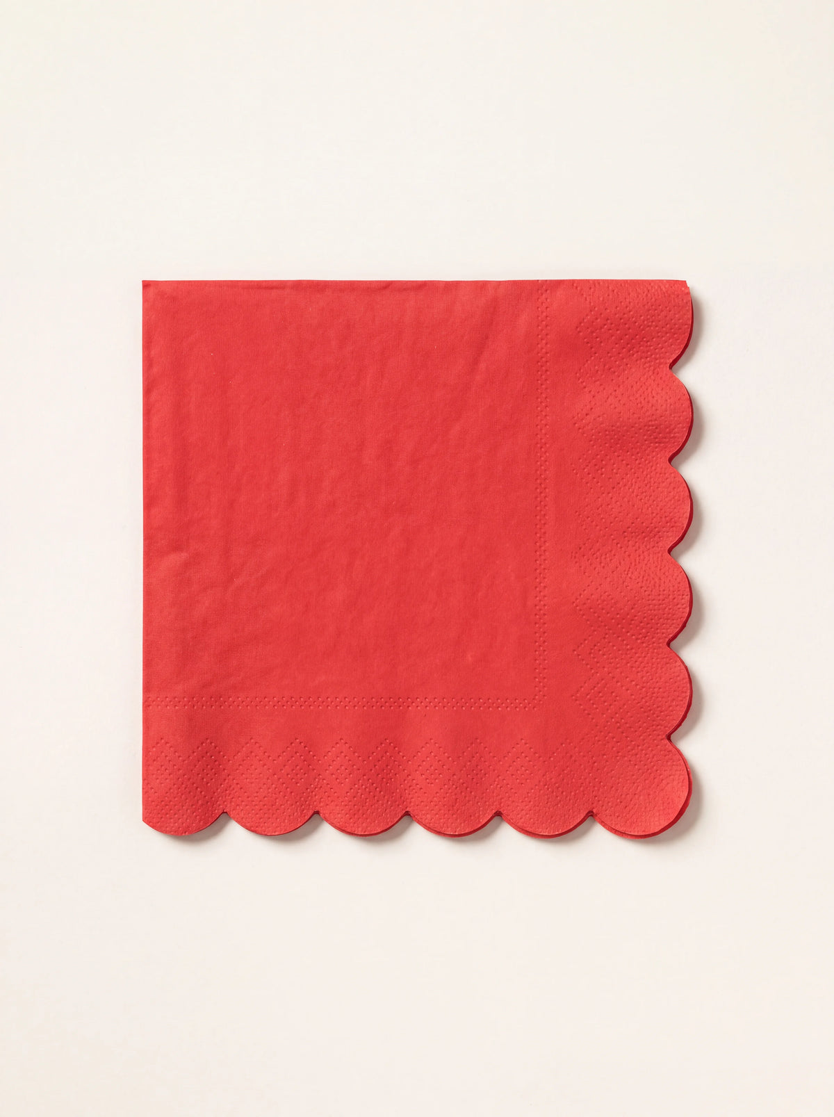 Square berry red paper napkin with scalloped edges and an embossed border pattern