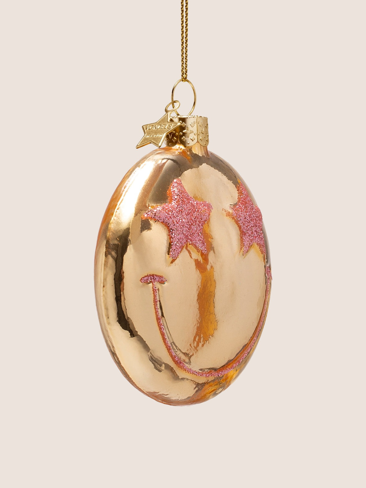 Three-quarter view showing the rounded disc shape and raised glitter stars