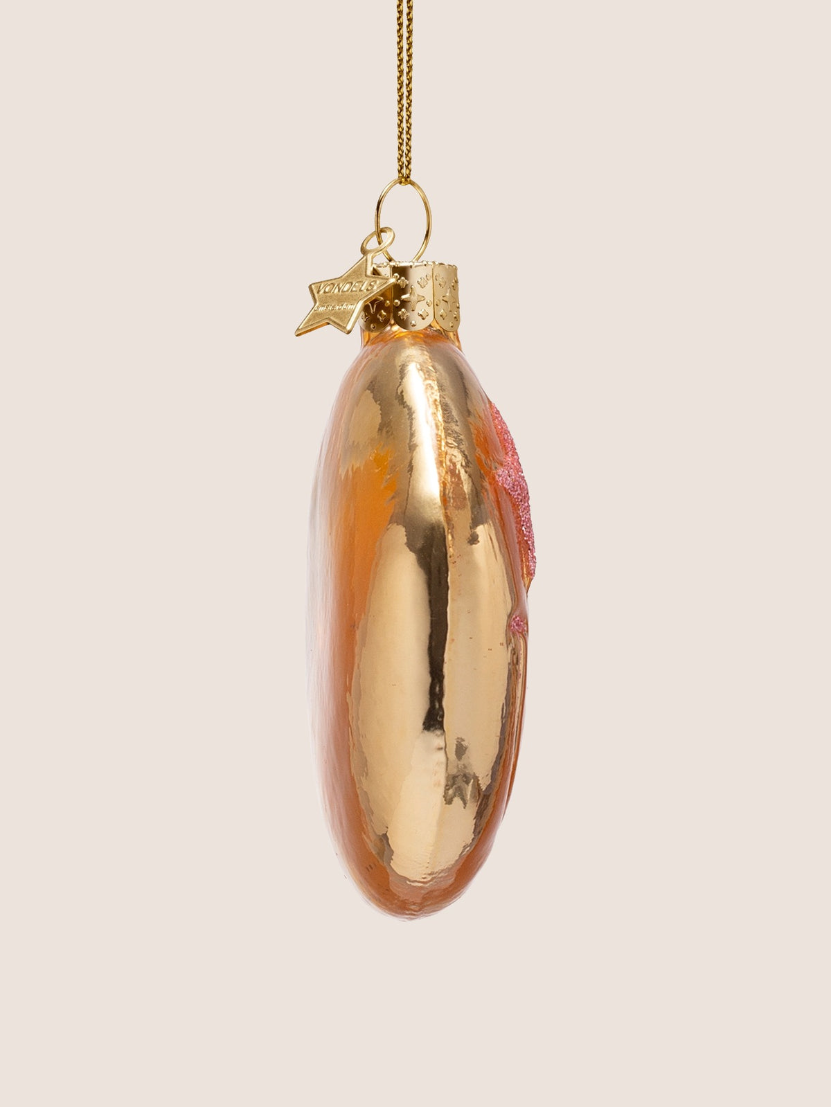Side profile showing the slim depth and reflective finish of the glass bauble
