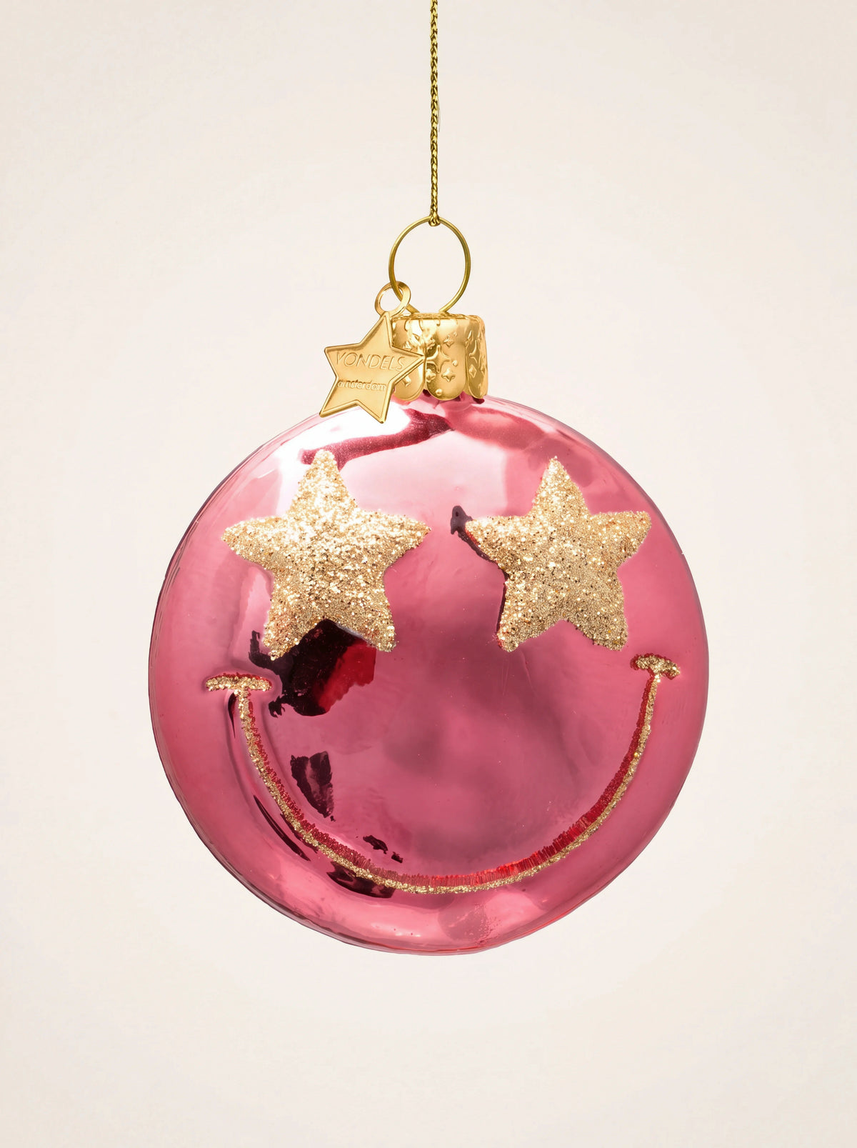 Shiny pink glass smiley face ornament with gold glitter star eyes and smiling mouth