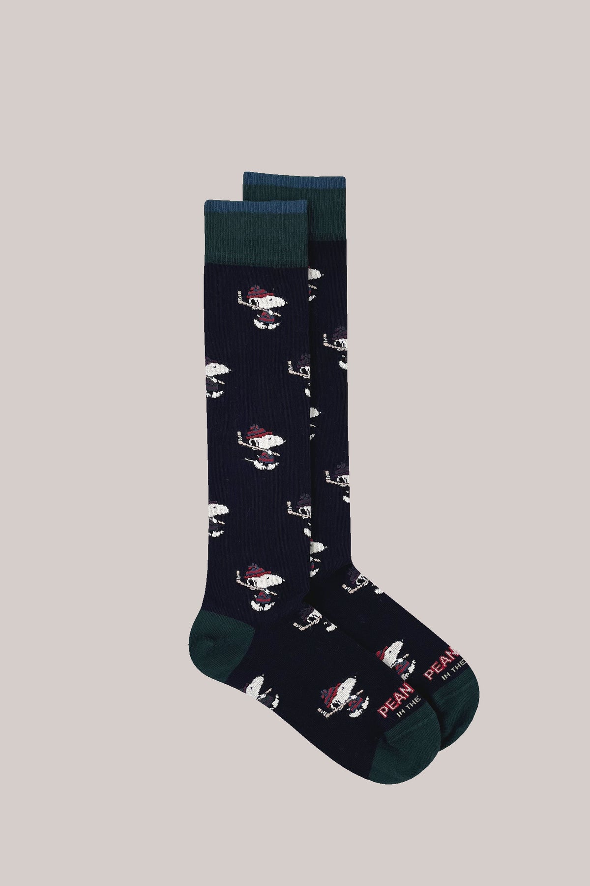 Navy knee-high socks with an ice hockey Snoopy pattern, ribbed green cuffs, heels and toes