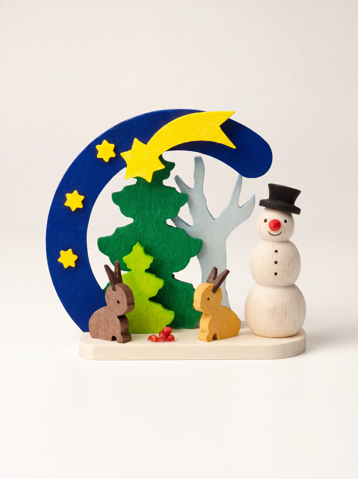 Maple wood ornament with a snowman, two hares and a shooting star under a blue arch