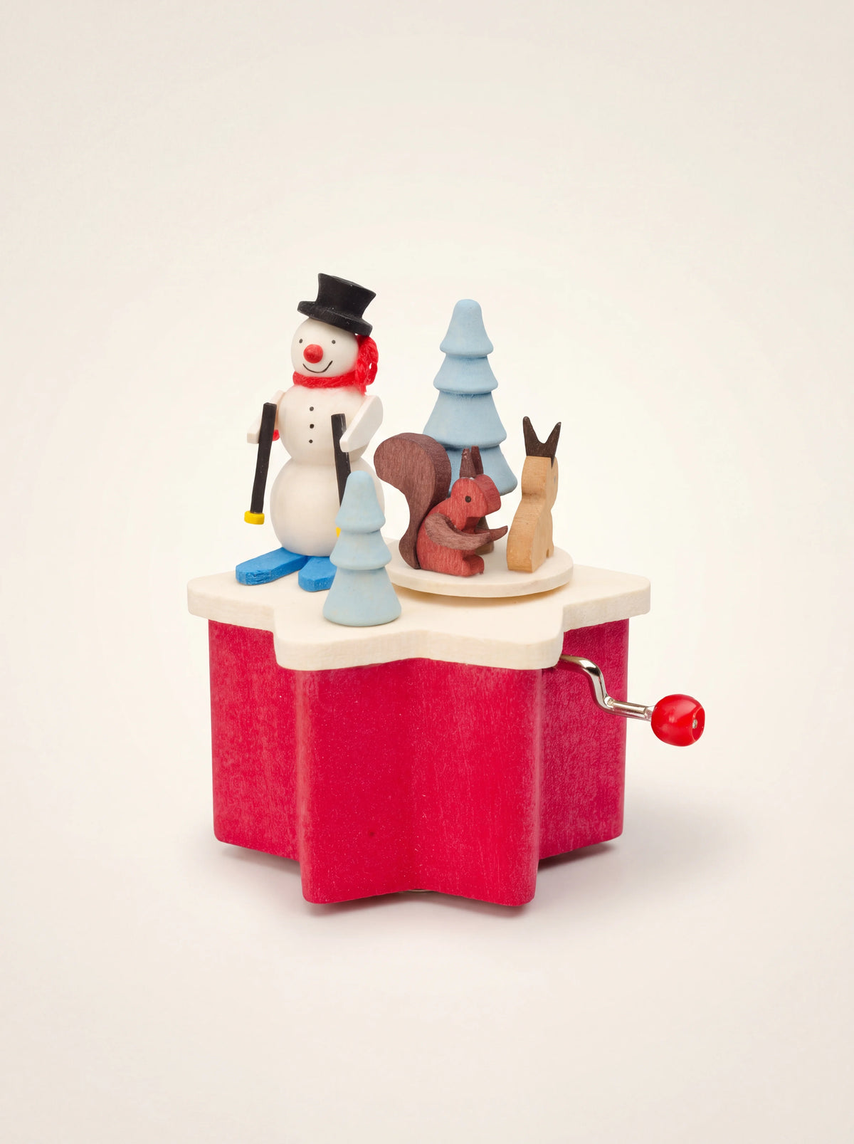 Sycamore wood music box with a red star base, hand crank, skiing snowman, trees, squirrel and hare