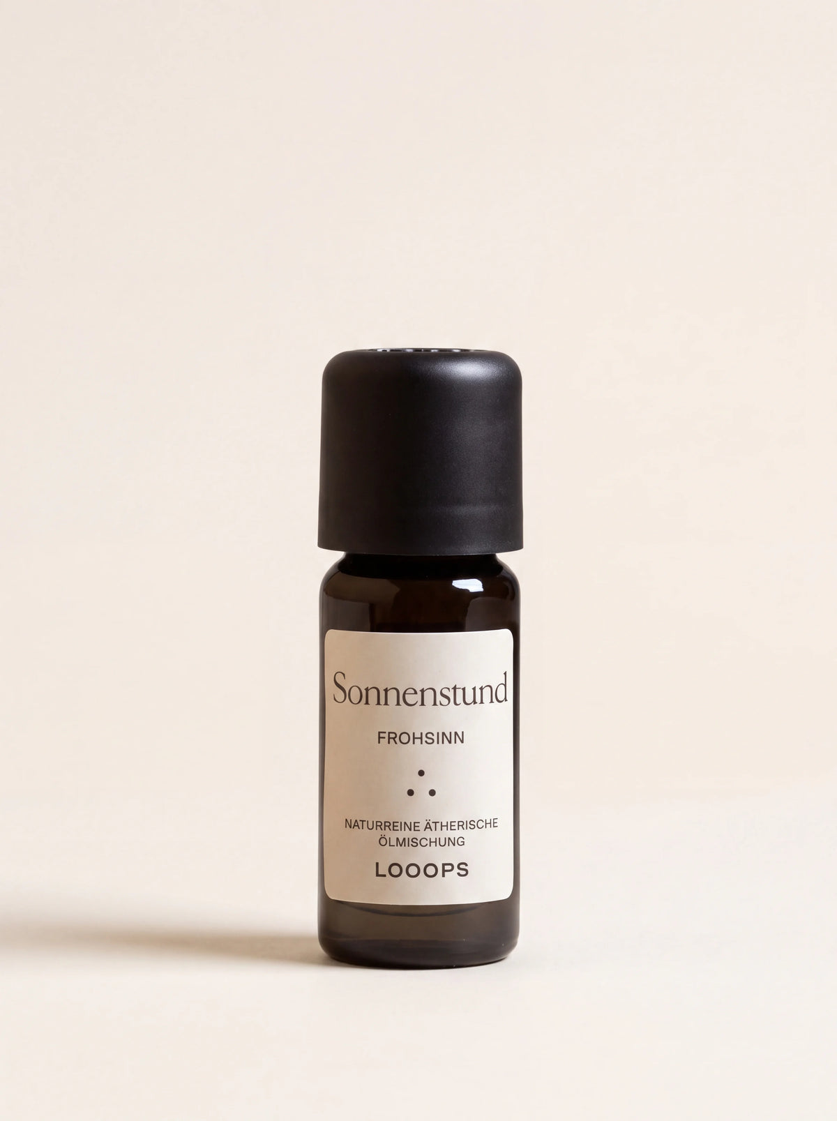 Sonnenstund essential oil in an amber glass bottle with a black cap and label reading Sonnenstund Frohsinn