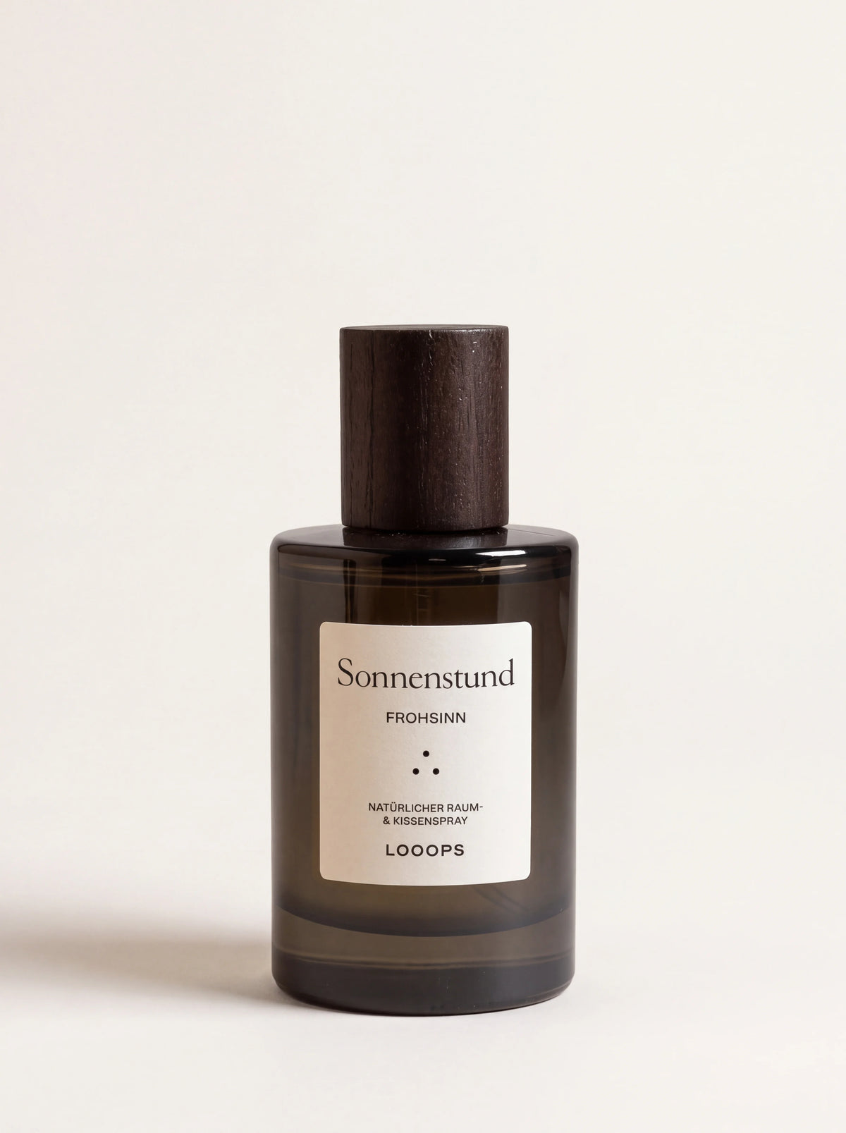 Room spray in a tinted glass bottle with a dark stained ash wood cap and Sonnenstund label