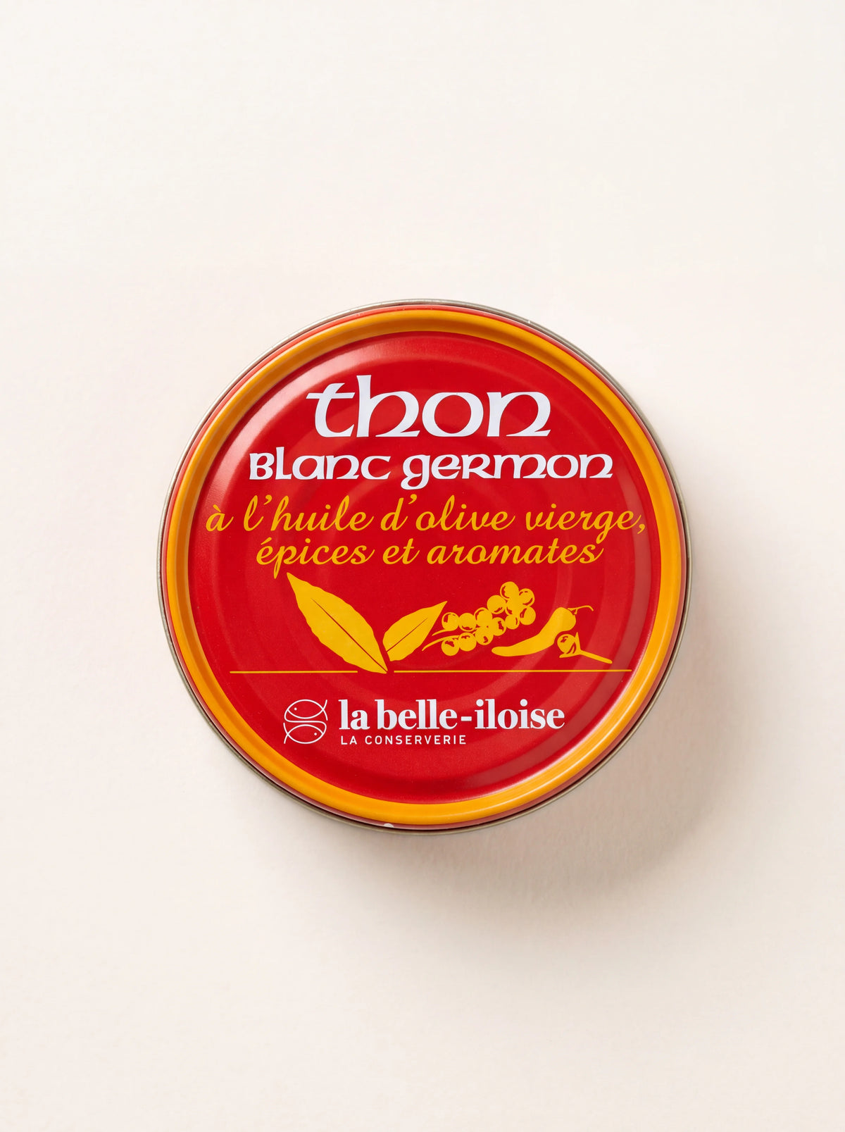 Round tin of albacore tuna labelled thon blanc germon à l'huile d'olive vierge, épices et aromates
