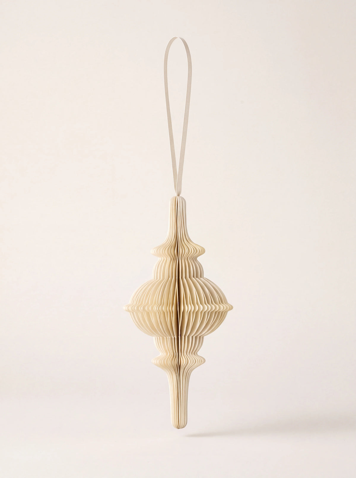 Cream pleated paper spire ornament with a matching ribbon hanging loop