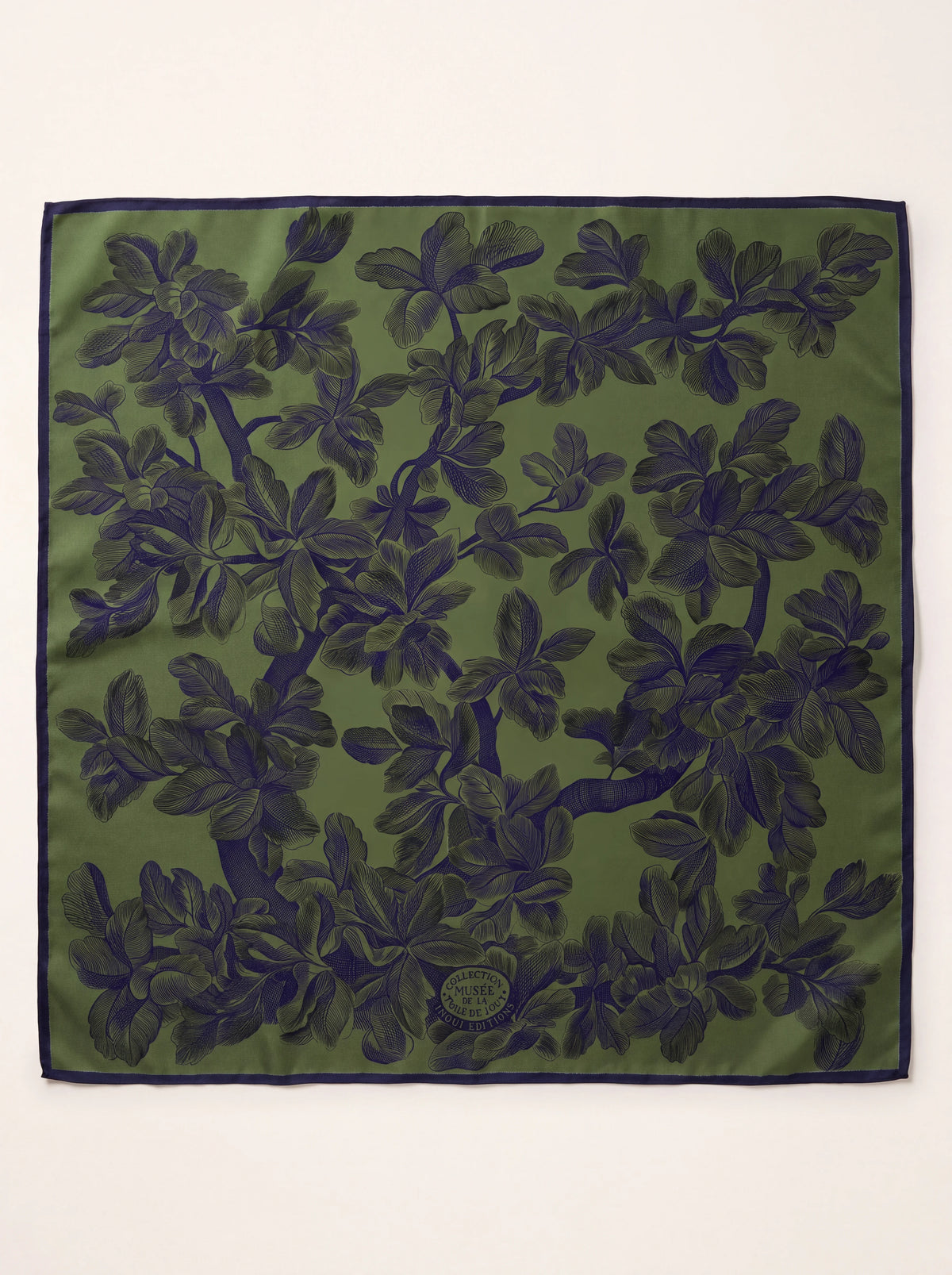 Square green wool scarf with dark botanical branches, a dark border and Musée de la Toile de Jouy emblem