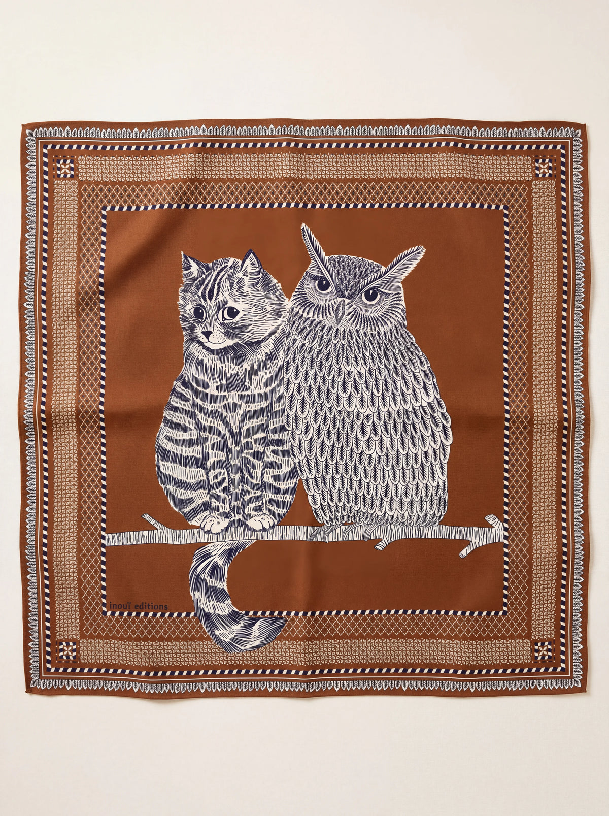 Square terracotta wool scarf illustrated with a cat and owl on a branch, framed by patterned borders