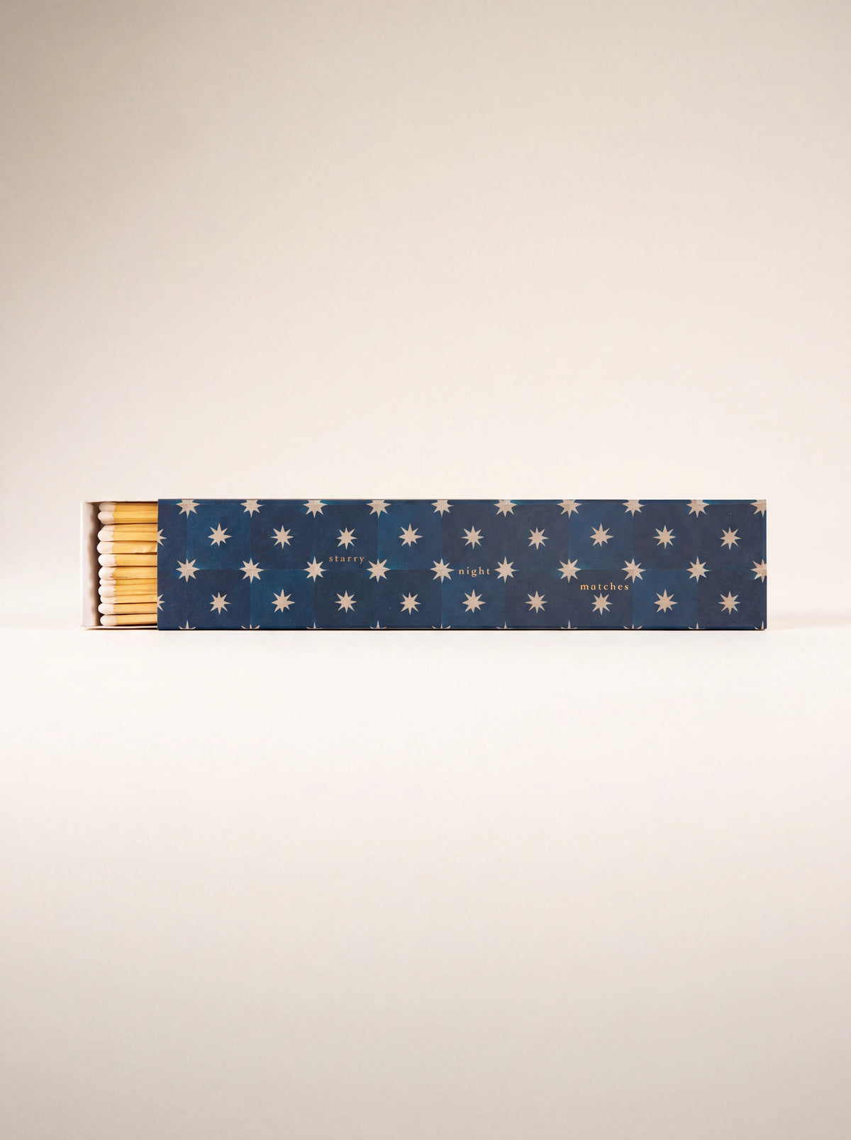 Long matchbox in dark blue with a star pattern reading starry night matches, slightly open at one end