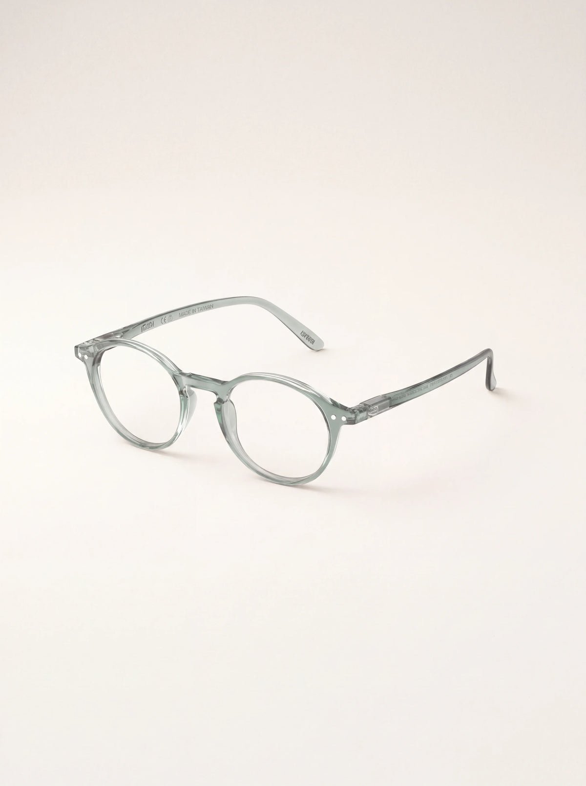 Pale green reading glasses angled to show the translucent arms and spring hinges