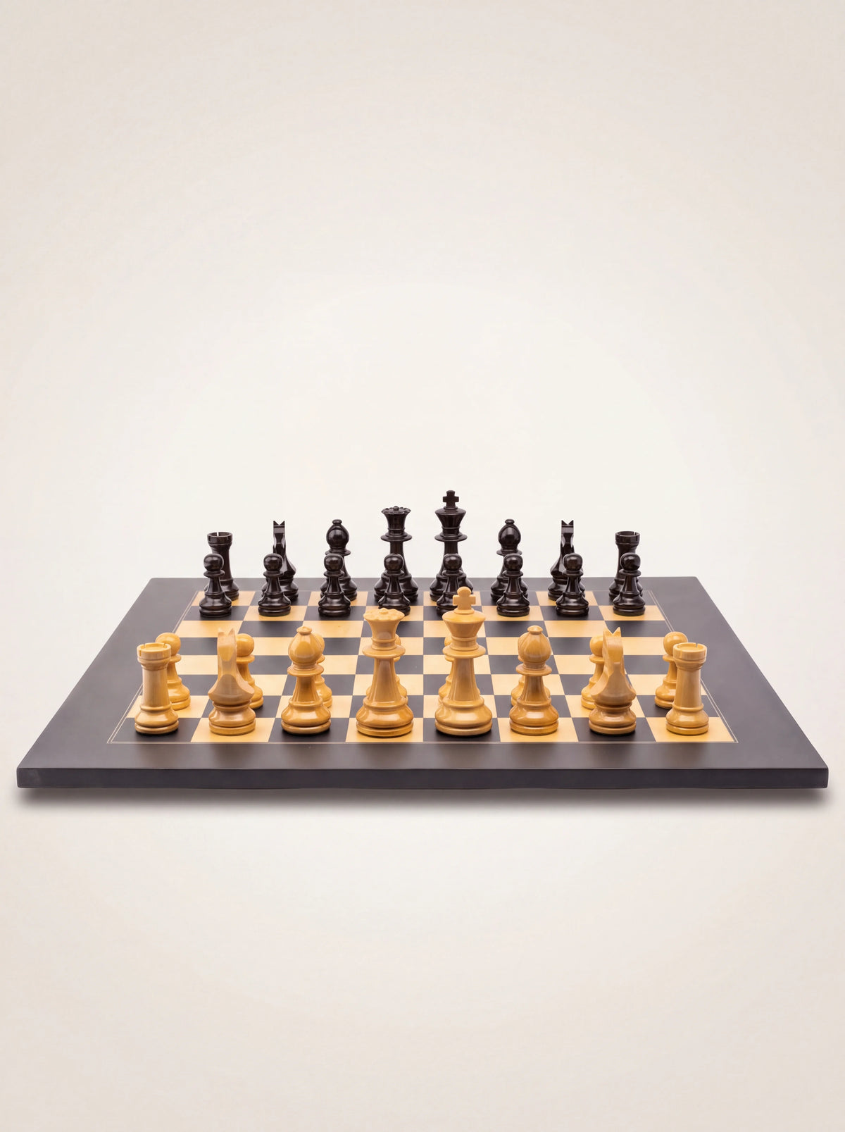 Staunton wooden chess set with glossy light and black pieces set up on a square board