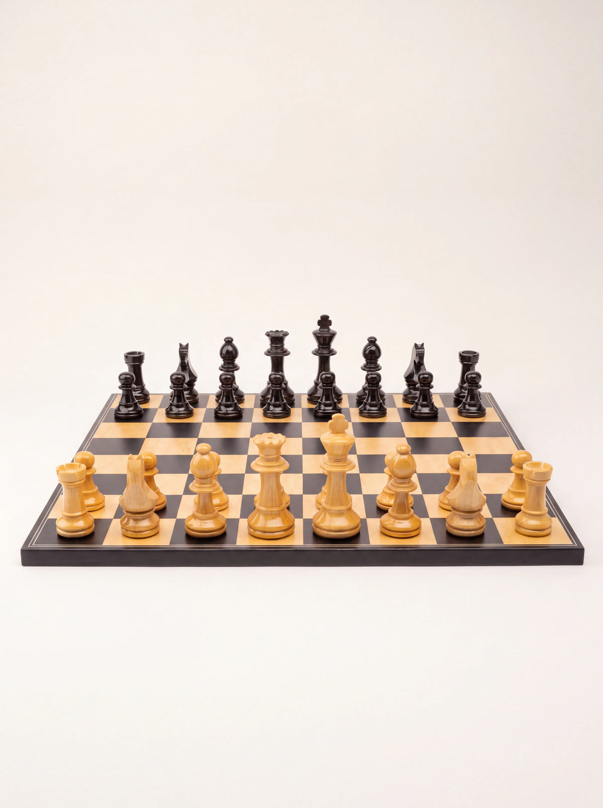 Straight-on view of the Staunton chess set showing the carved profiles and heights of the pieces