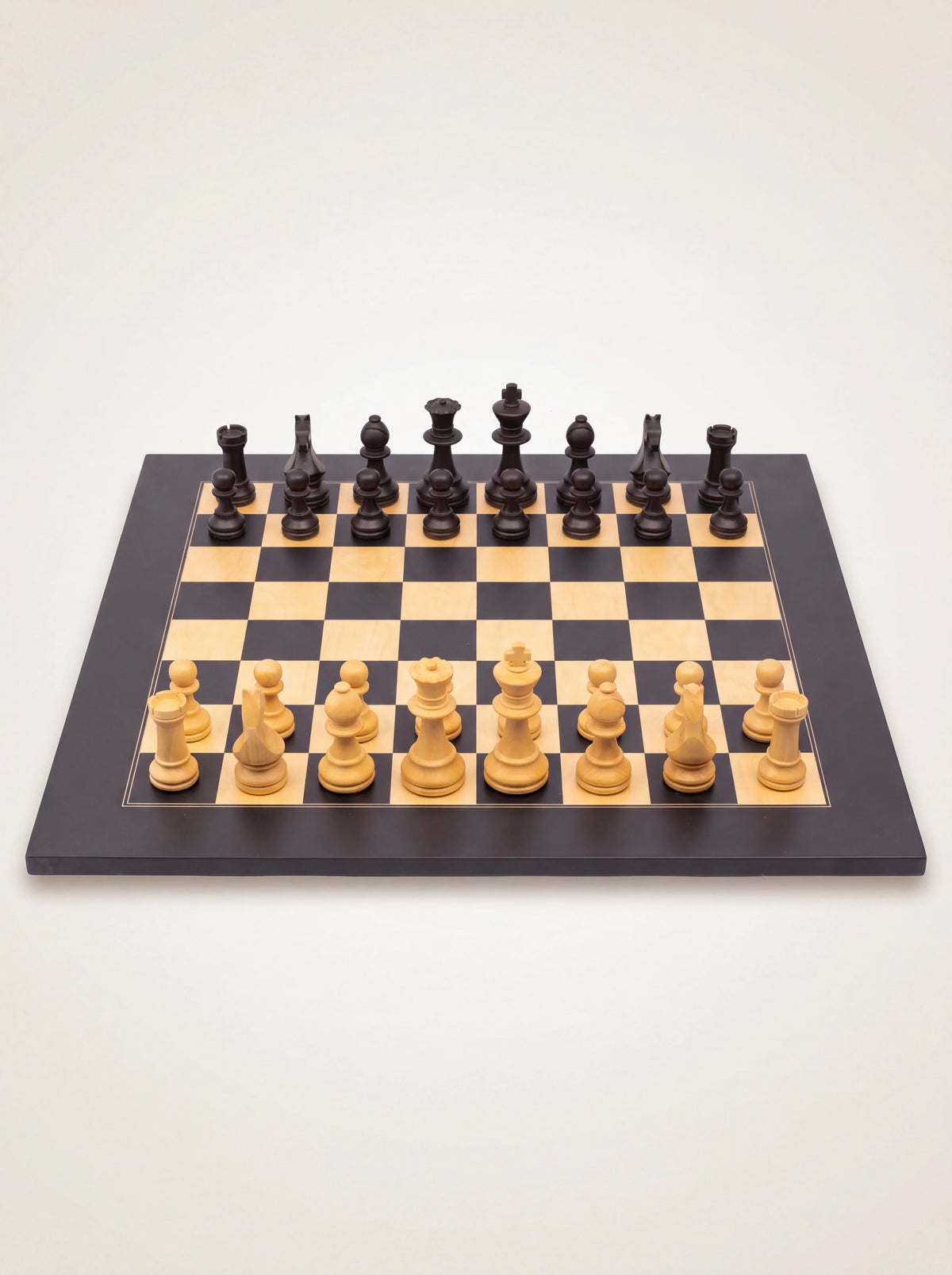 Low-angle view of the Staunton chess set showing the profiled shapes and carved details of the pieces