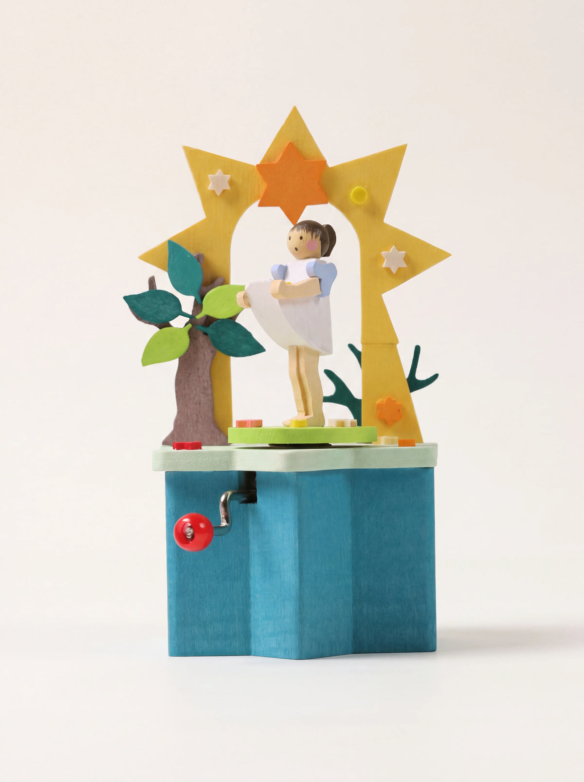 Painted wooden music box with a Sterntaler figurine under a yellow star arch on a blue base with a crank