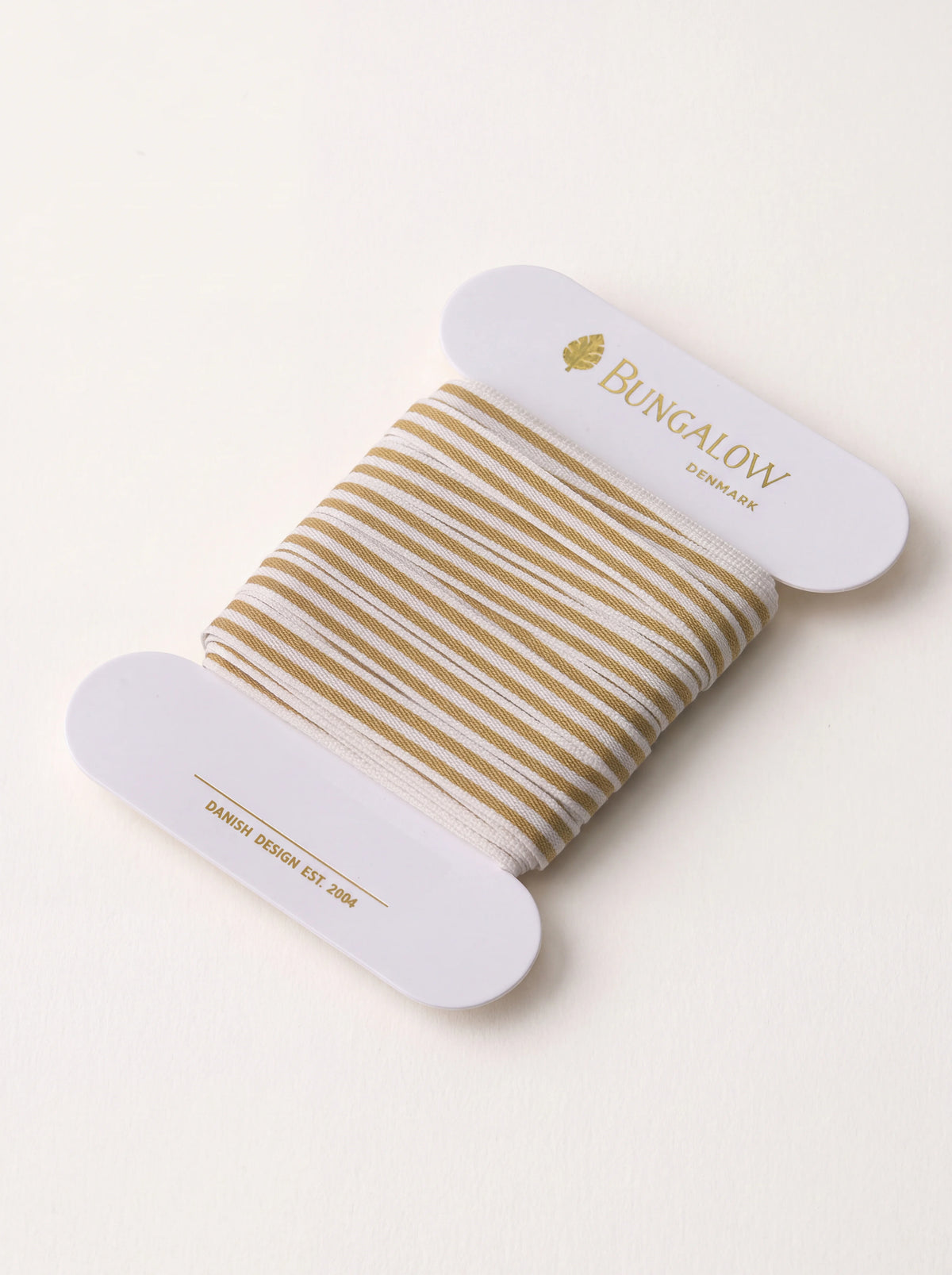 Dijon-yellow and white striped polyester ribbon wound around a white card spool