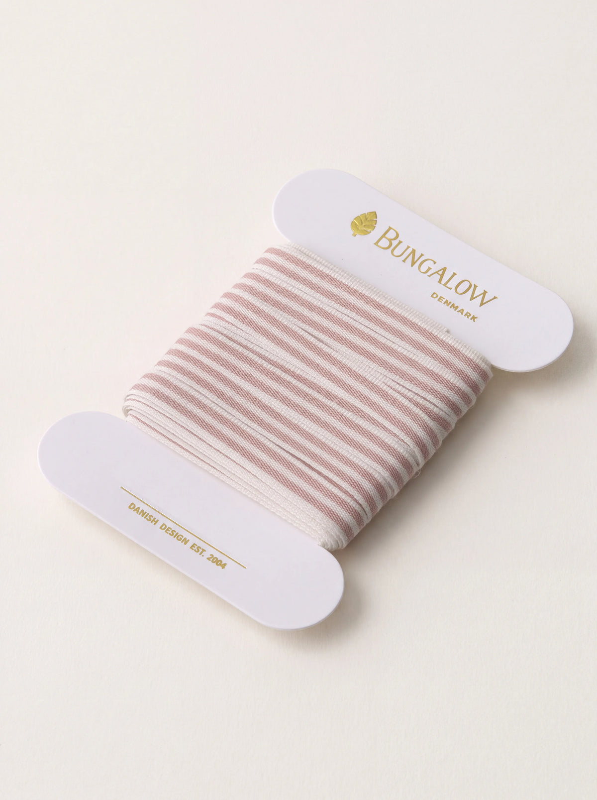 Rose-pink and white striped polyester ribbon wound on a white card spool