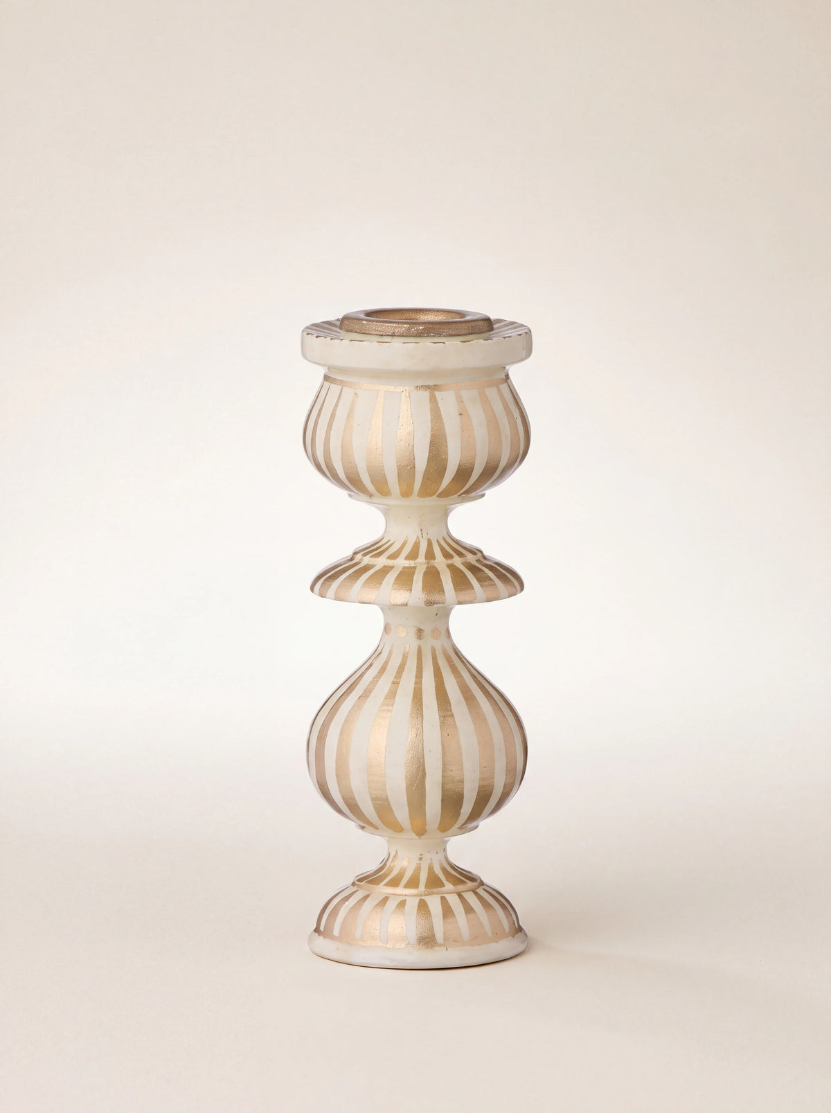 Turned wooden candle holder in cream and gold with bulbous sections and vertical painted stripes