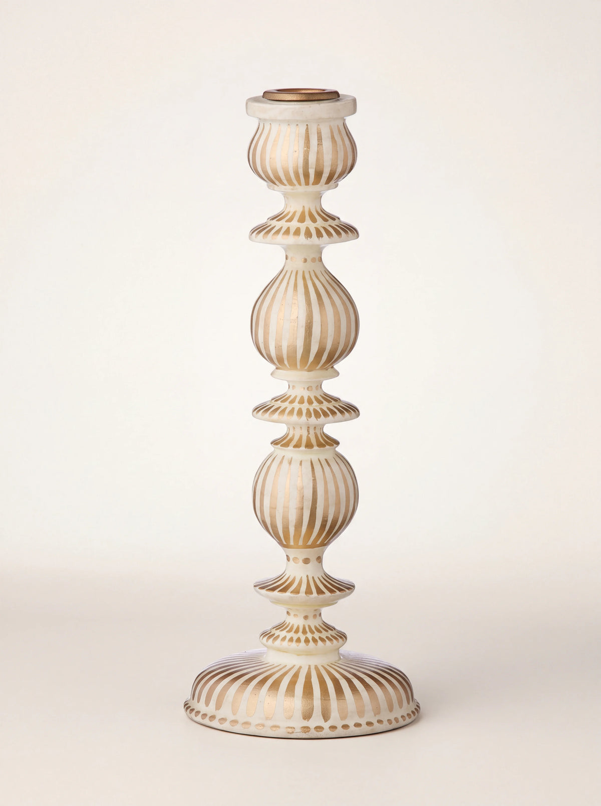 Turned wooden candle holder with hand-painted gold stripes, tiered silhouette and round base