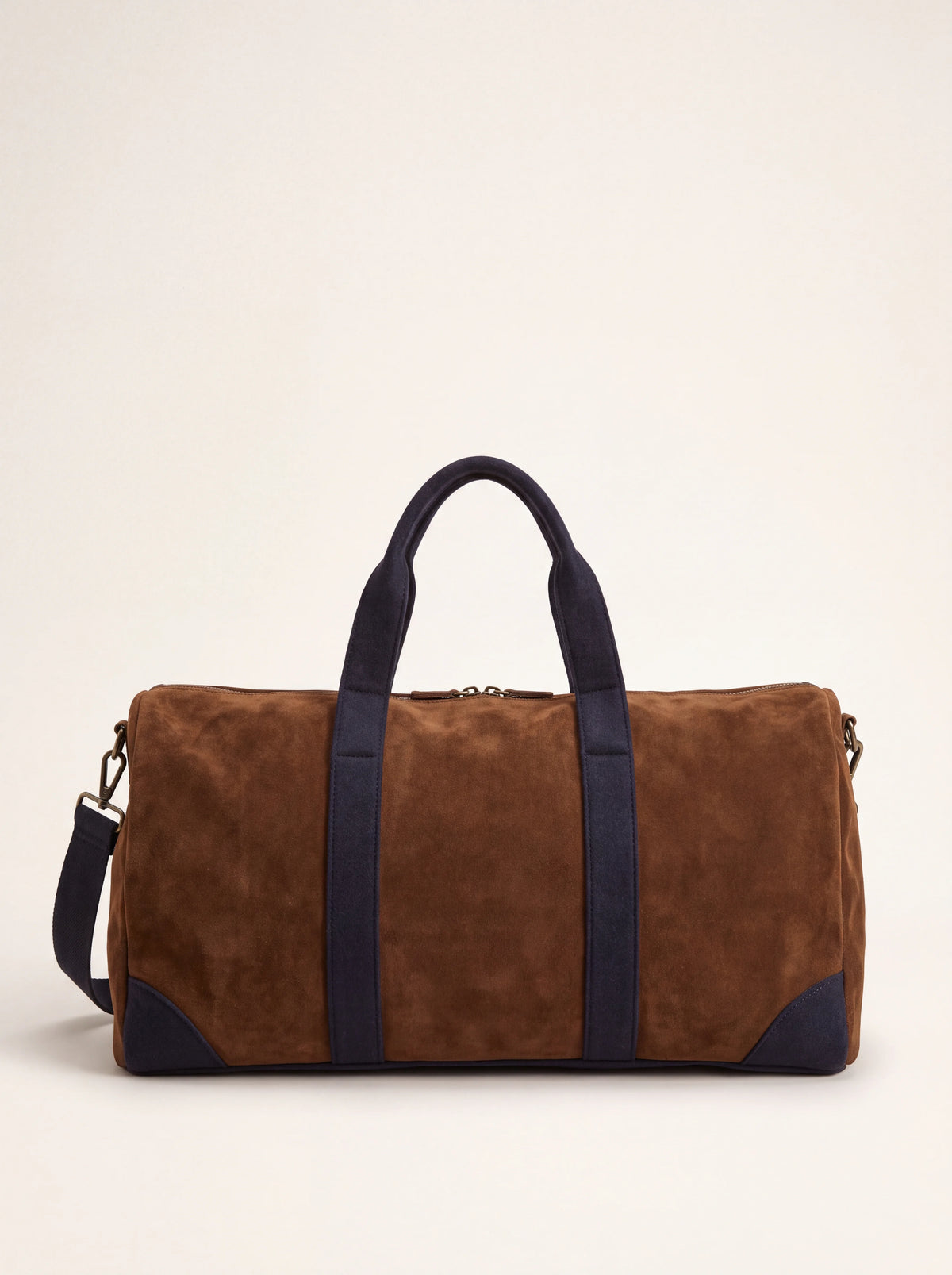 Brown suede duffle bag with blue felt handles, reinforced corners and a shoulder strap